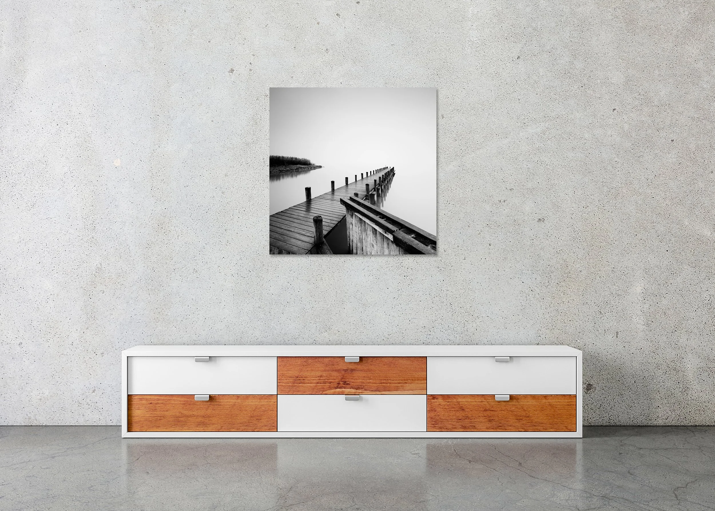 Wooden pier extending into a calm misty lake, black-and-white photo with shoreline reeds, photo print mounted to Dibond, frameless