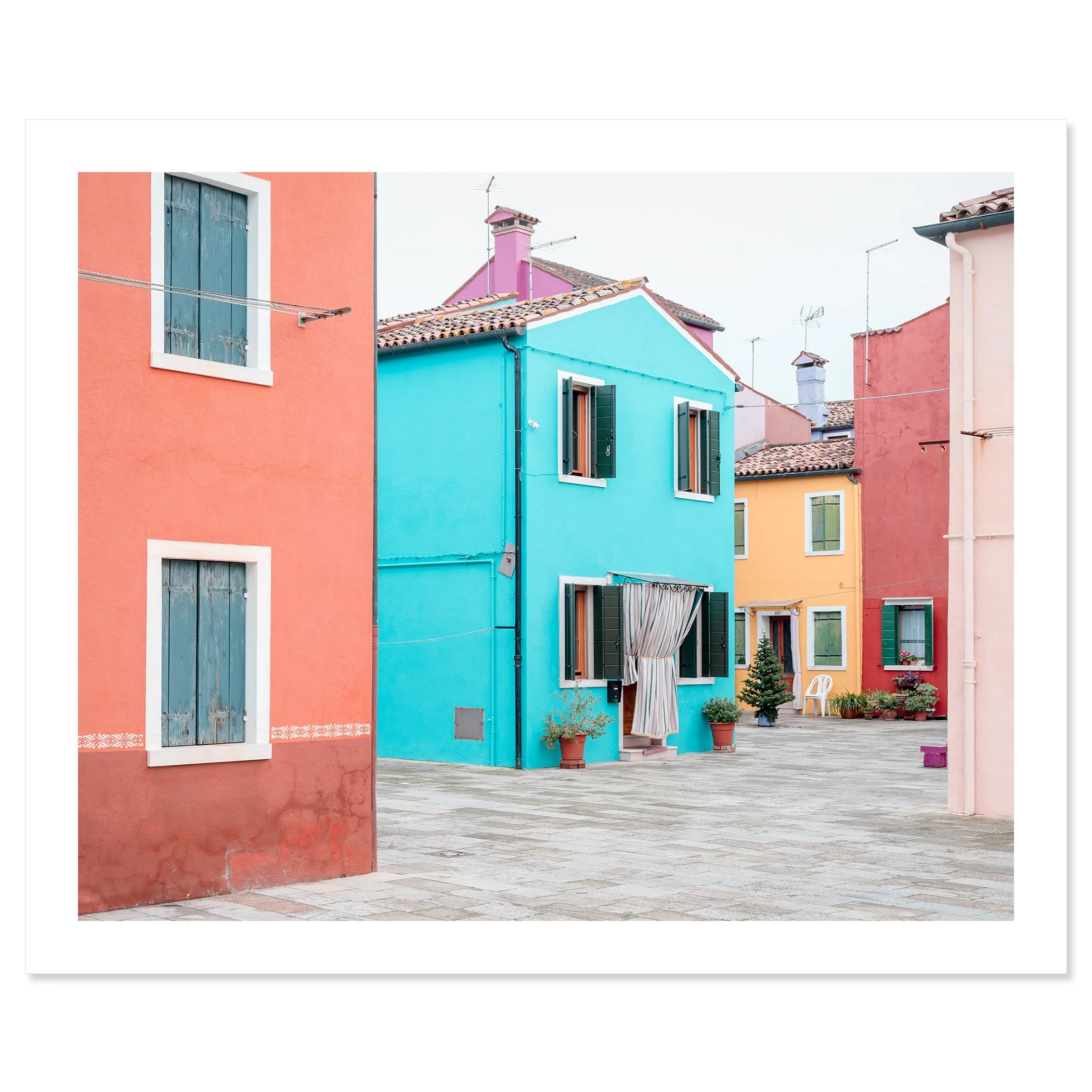 © 2025 Gerald Berghammer - Color cityscape photography. Colorful buildings with pastel pink, blue, yellow, and red walls, windows, and open shutters in a courtyard. Fine art print only