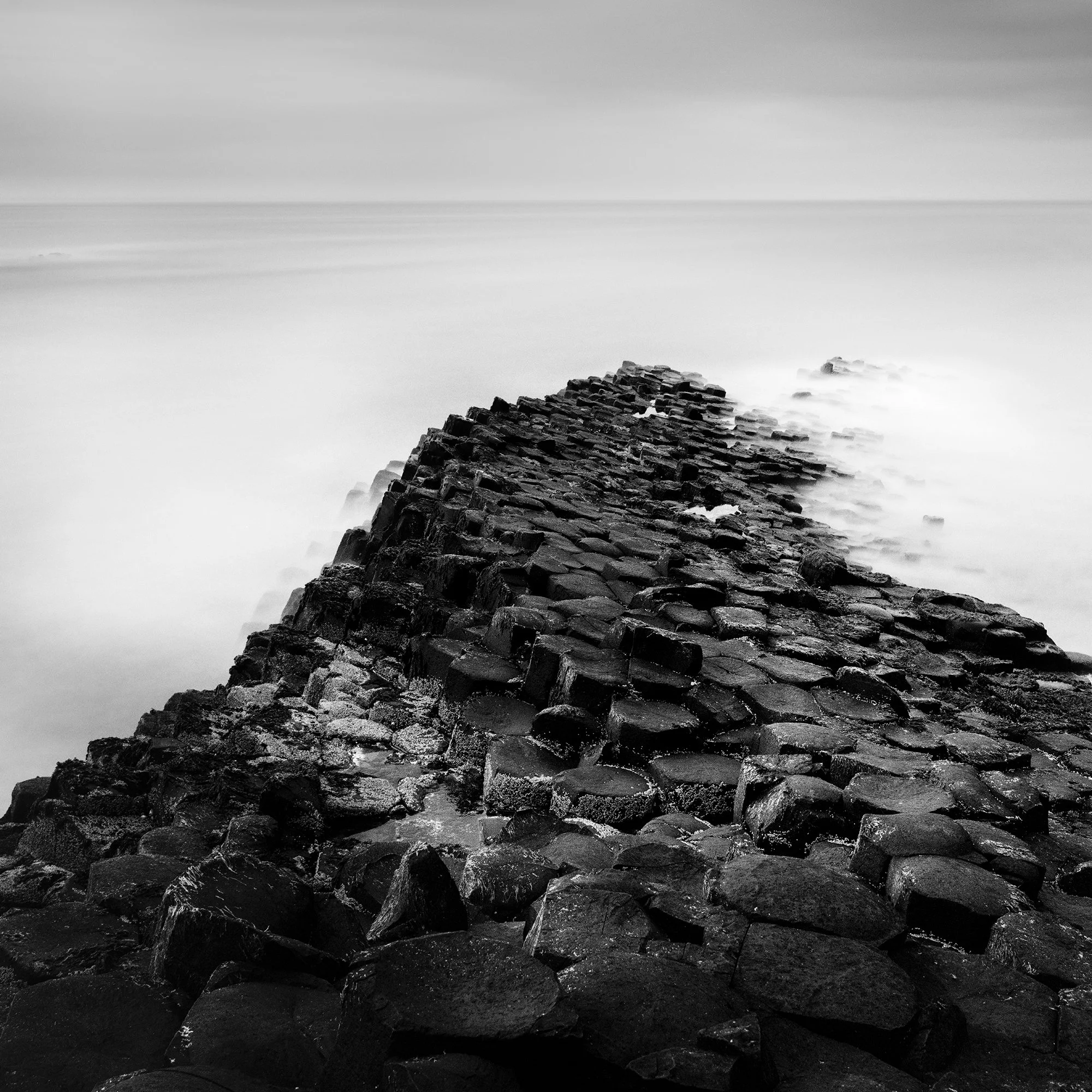 Detail of Giant’s Causeway Study 2 showing basalt columns and the long-exposure sea by Gerald Berghammer.