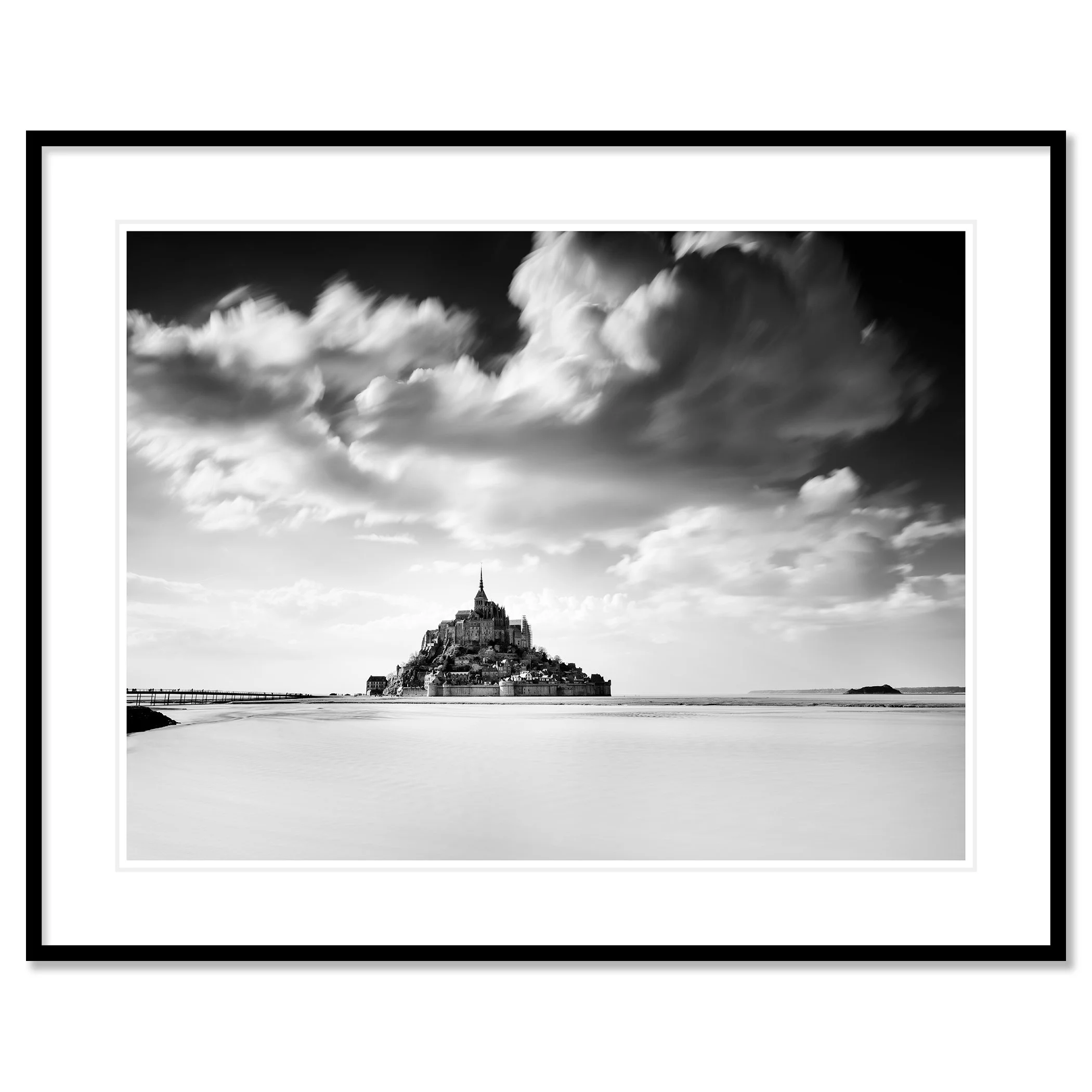 © 2023 Gerald Berghammer - B&W photography. Mont Saint-Michel, a historic island with a tall spire and medieval architecture, surrounded by water and clouds. Classic framed black