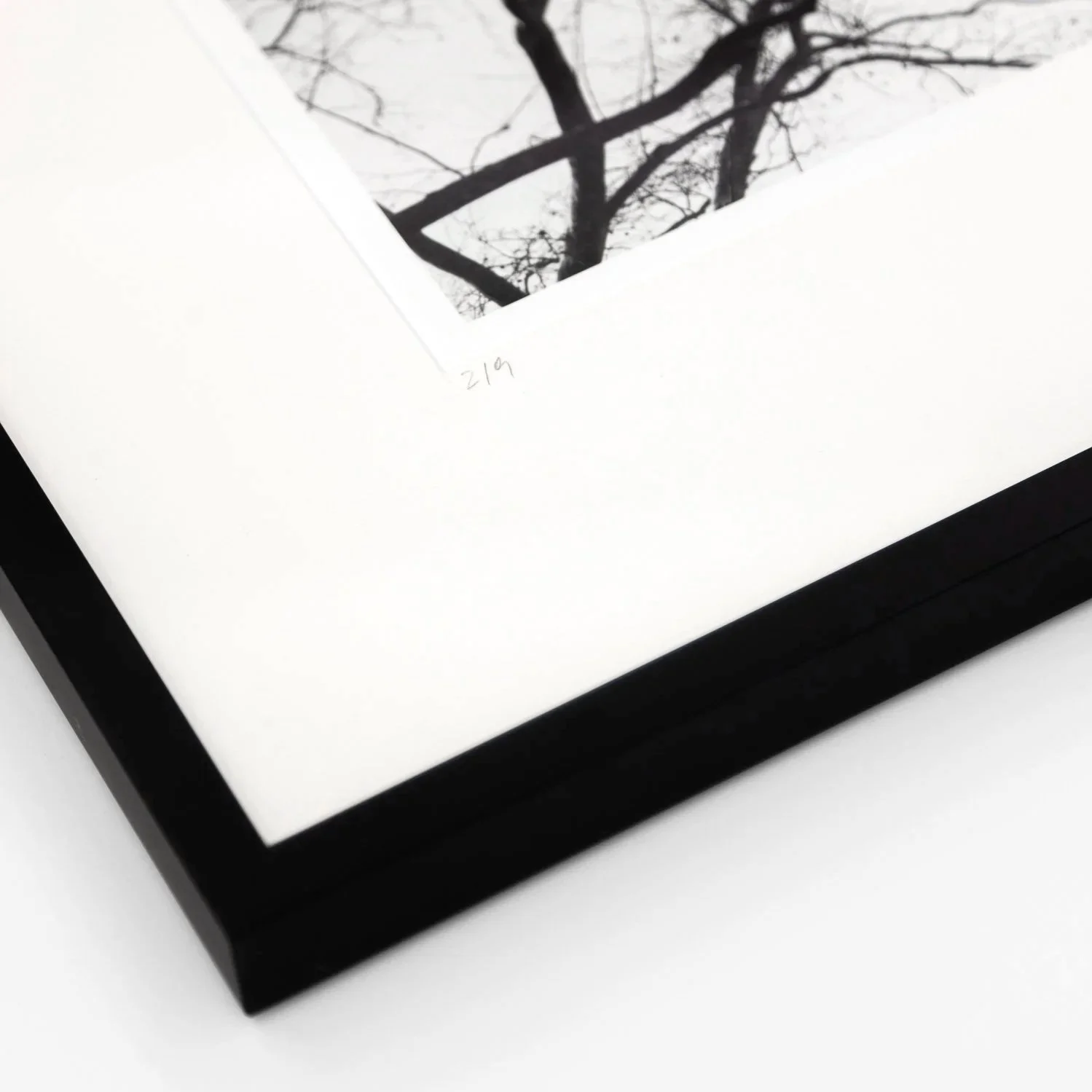 Detail of handwritten edition number 2/9 and the black wooden frame of Flatiron Building 1 by Gerald Berghammer.