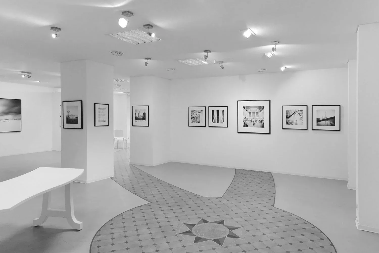 Wide interior view of Galerie STP during ESSENTIAL LIGHT 2018 in Greifswald, displaying black-and-white architectural photographs by Gerald Berghammer.
