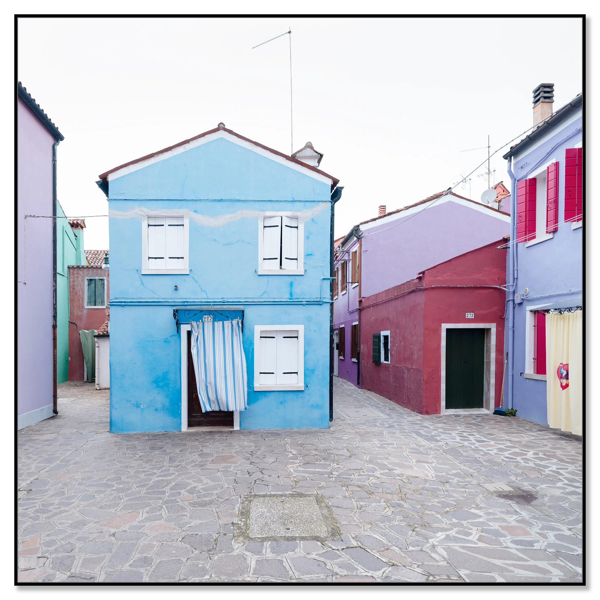 Traditional colourful houses in Burano, Venice, with shutters and a cobbled walkway – framed ArtBox black