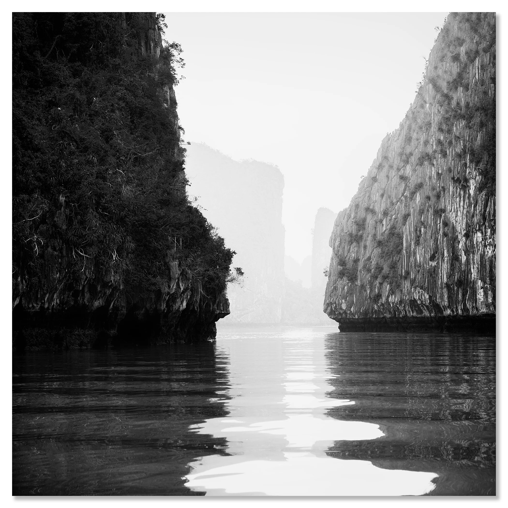 Karst limestone cliffs mirrored in calm water, black-and-white fine art photo, Ha Long Bay – dibond frameless