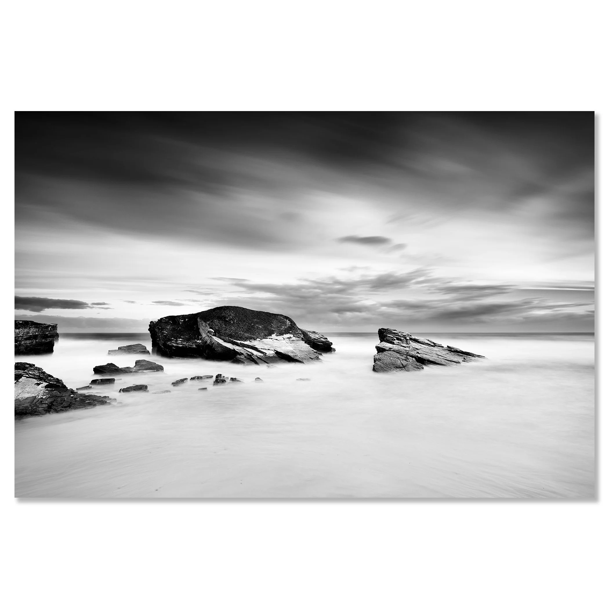 Monochrome long-exposure seascape with rocky coast and large rocks beneath overcast skies – dibond frameless