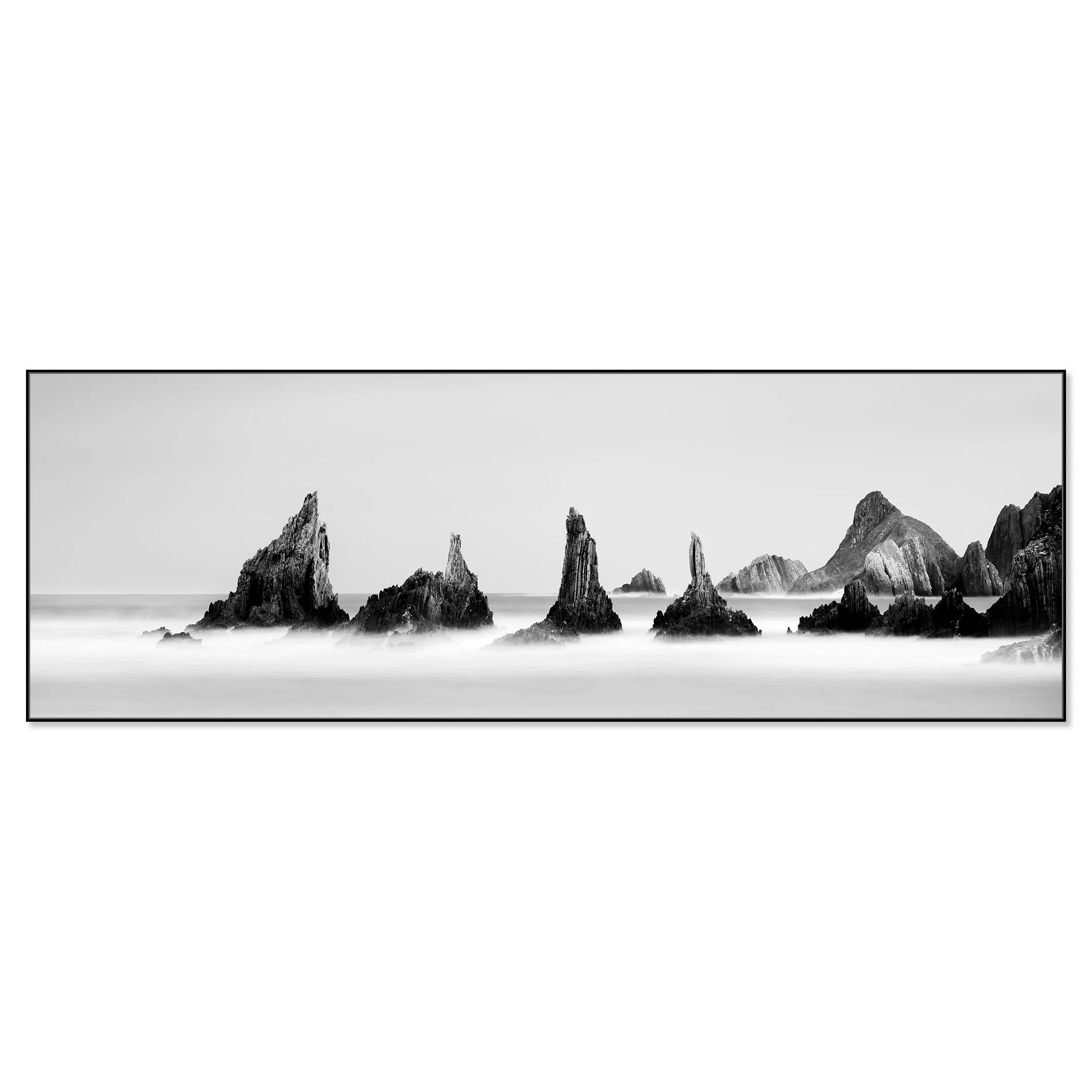 Fine art monochrome seascape showing rugged offshore rocks surrounded by misty surf – framed ArtBox black
