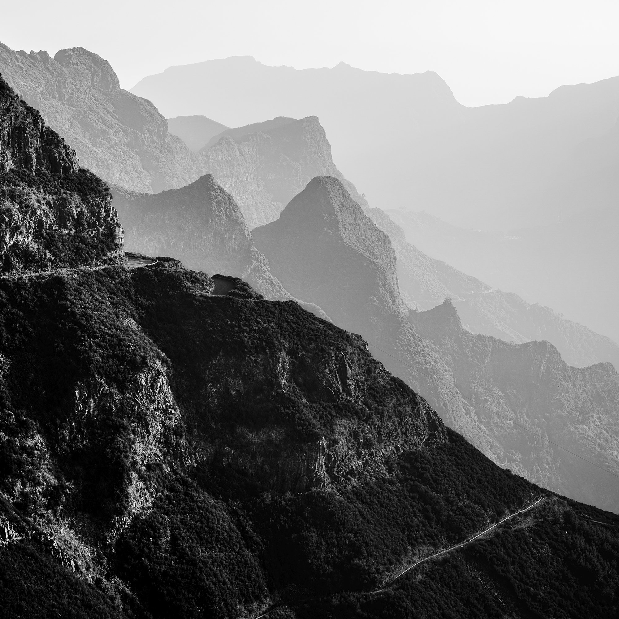 Madeira Peaks Study 1 by Gerald Berghammer, close-up of atmospheric mountain ridges and a winding road in Madeira, Portugal.