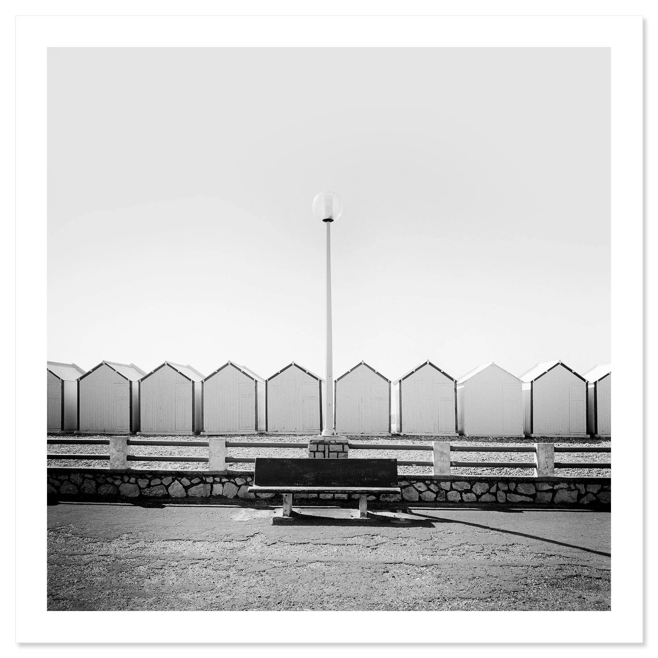 Bench on the Promenade Study 1 shown as an archival pigment print with a white border by Gerald Berghammer.