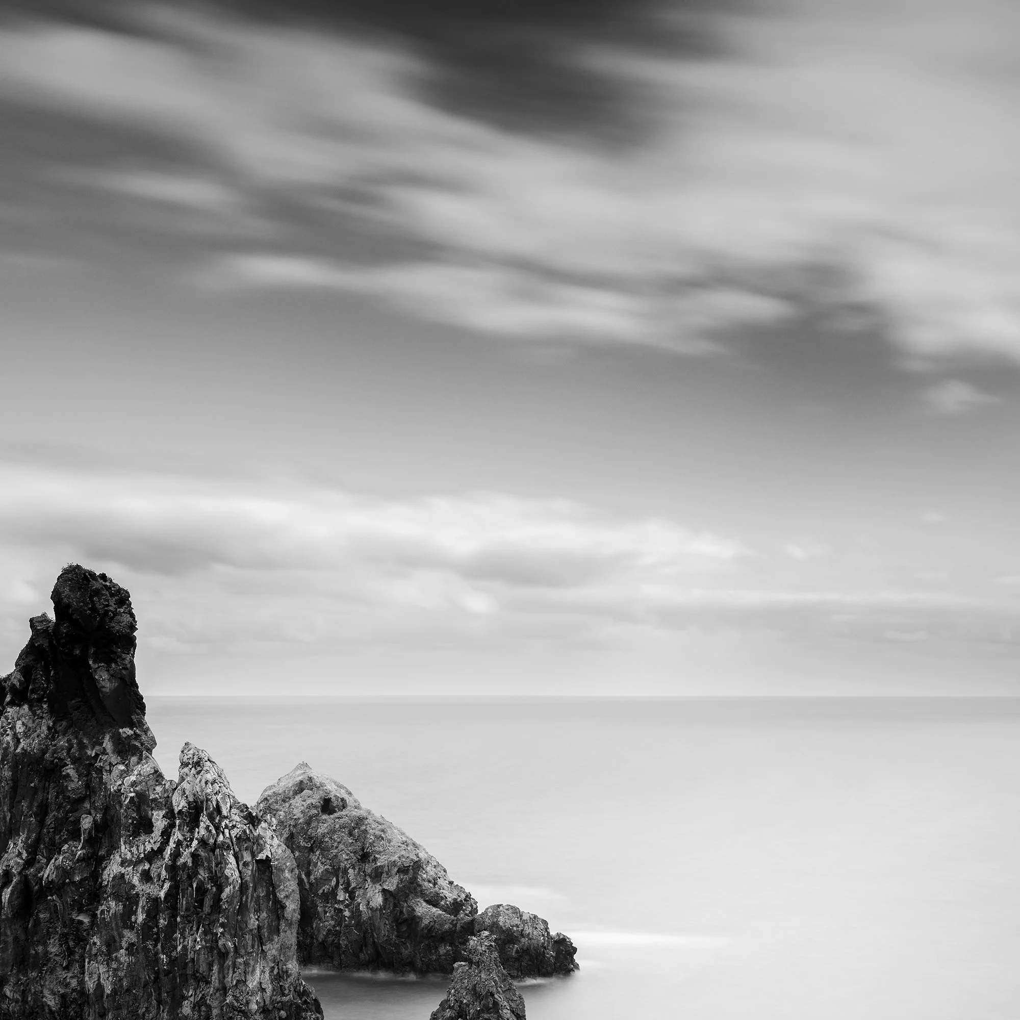 Ribeira da Janela Rocks Study 1 by Gerald Berghammer, detail of volcanic rocks beneath a dramatic clouded sky in Madeira.