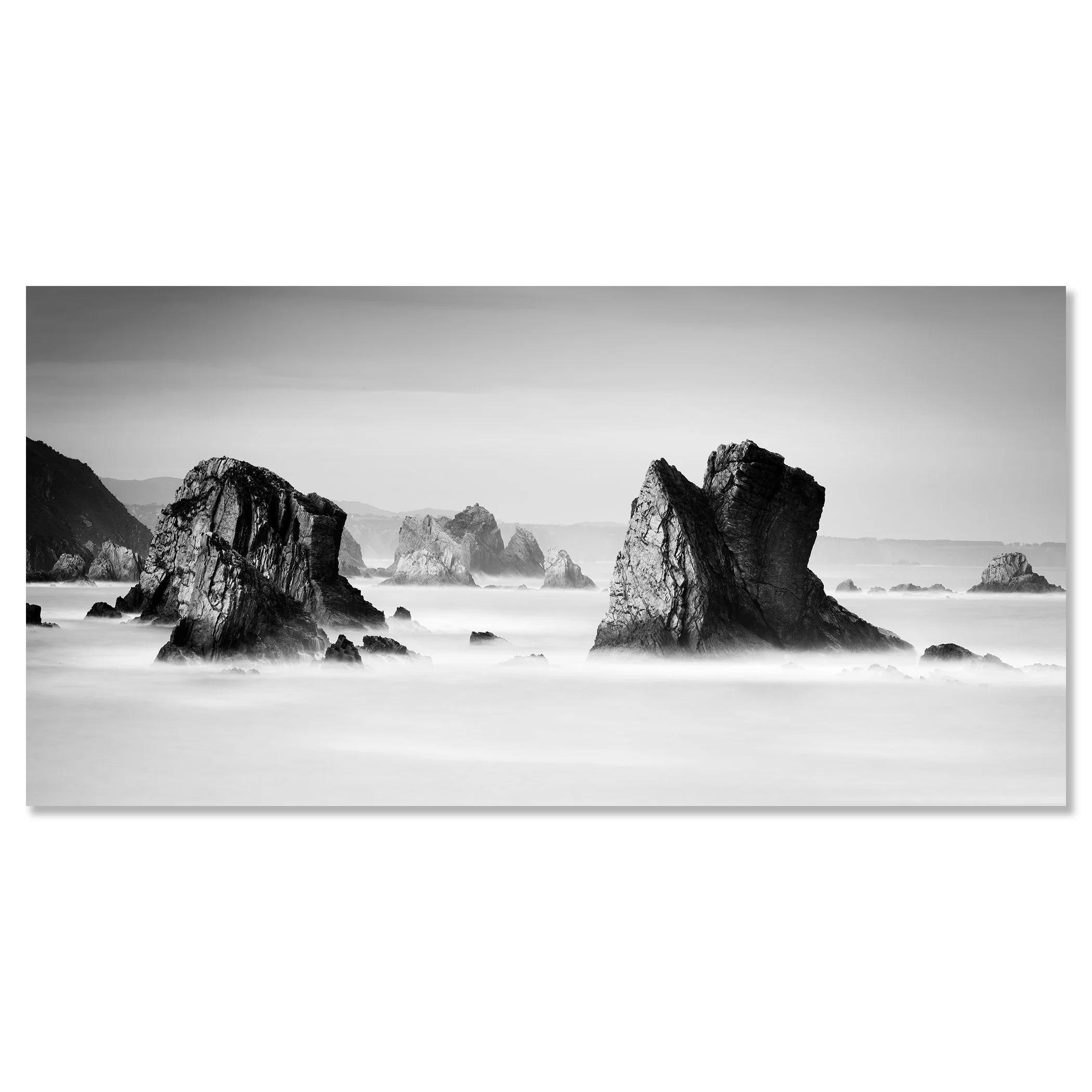 Black-and-white photo of rocky sea stacks and misty ocean waves on a rugged coast – dibond frameless