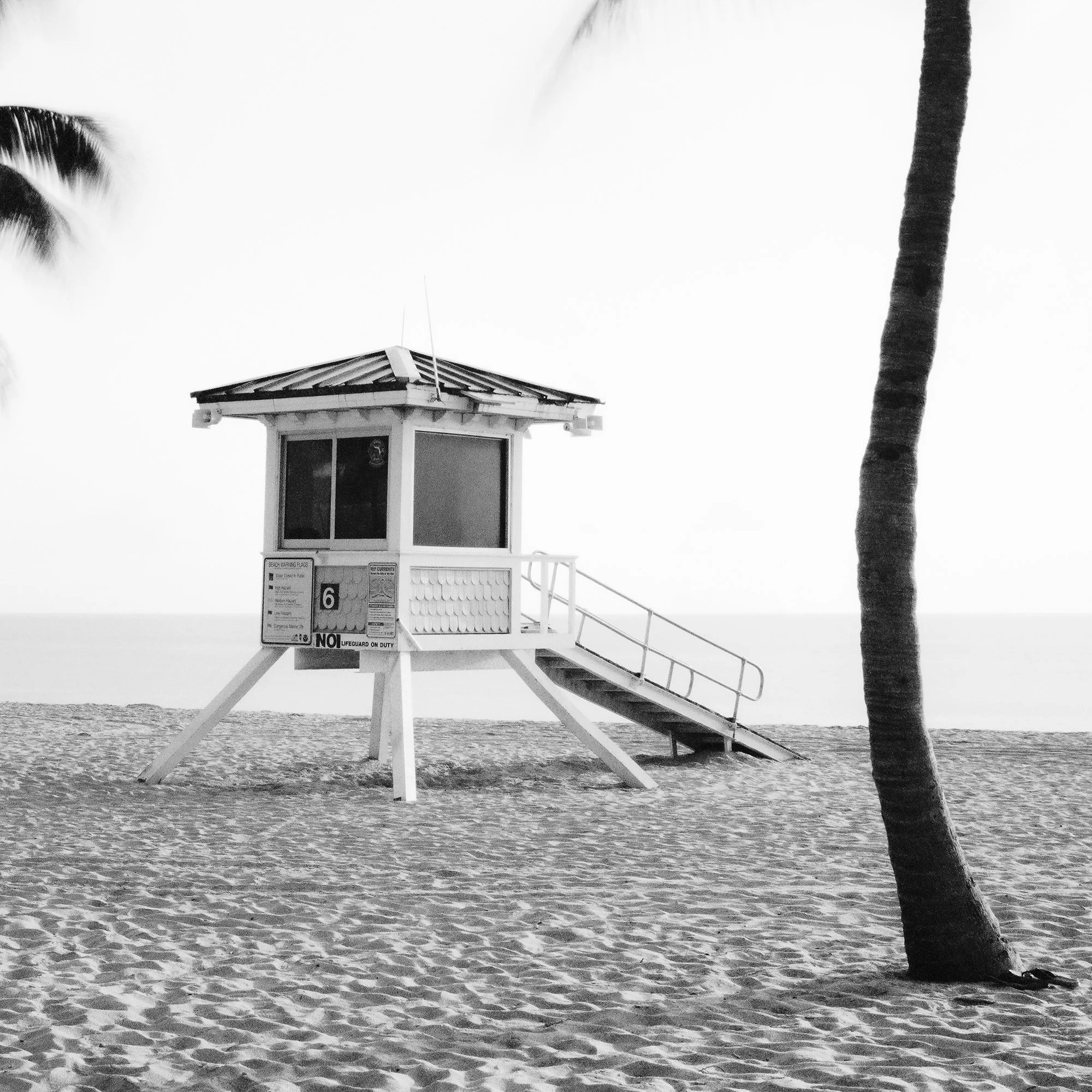 Fort Lauderdale Beach, Study 4 by Gerald Berghammer, close-up of the lifeguard tower, access ramp and palm trunk on the sandy beach.