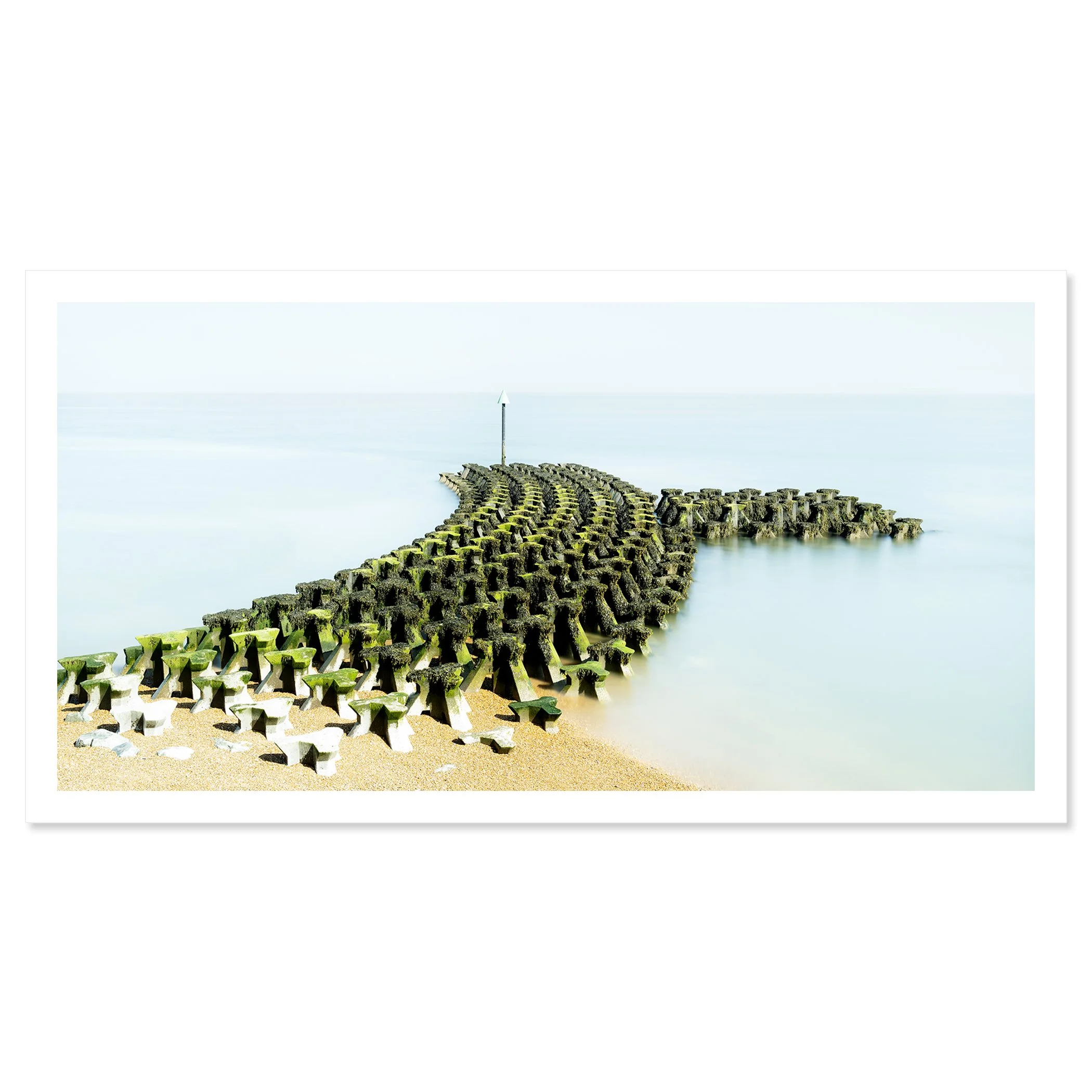Gerald Berghammer - Color seascape panorama photography. Concrete breakwater structures on a beach extending into the water, with a pole at the end. Fine art print only