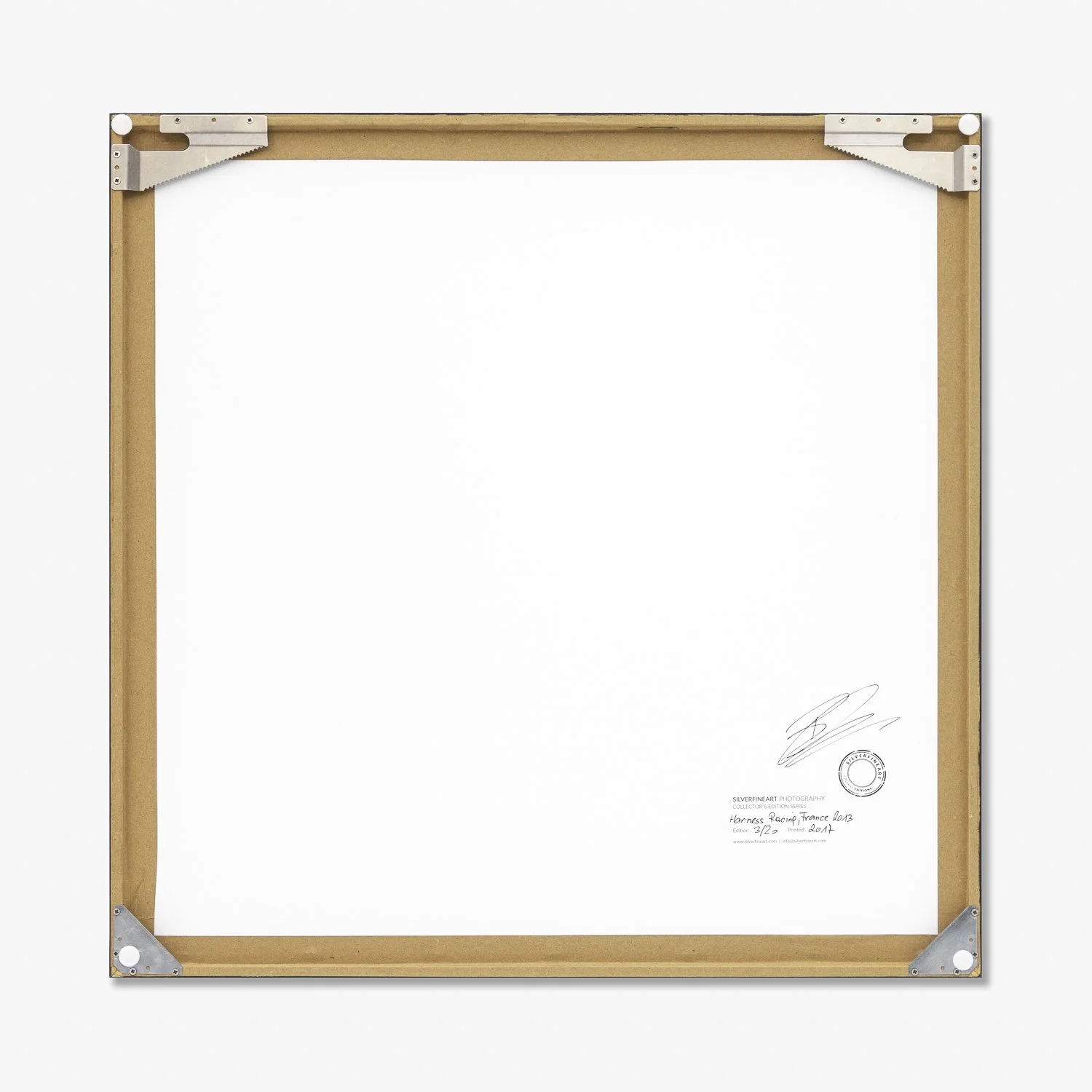 Reverse of Harness Racing – France by Gerald Berghammer, showing the handmade wooden frame, artist's signature and metal corner fittings.