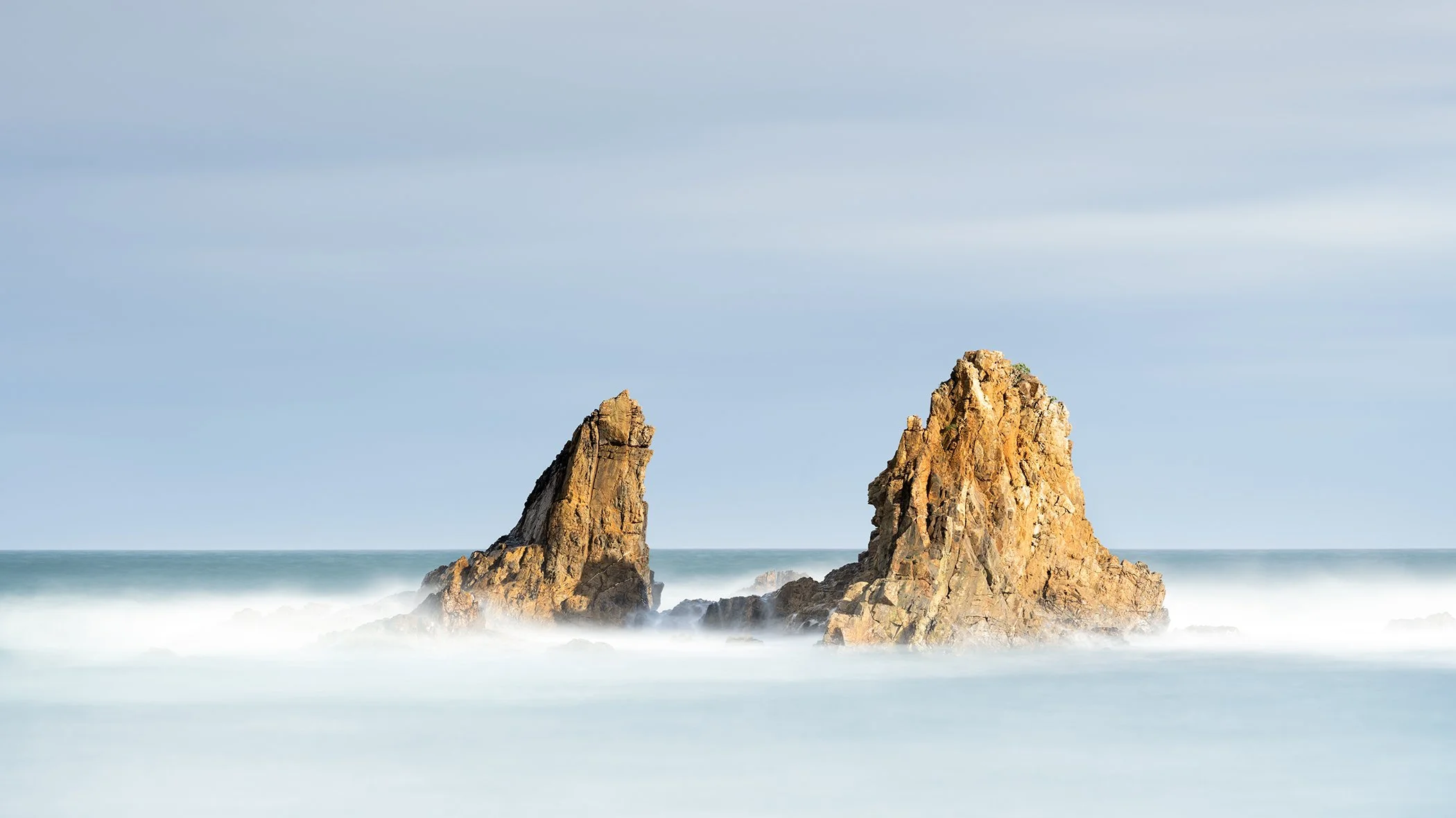 Coastal rock formations in a calm sea, photo by Gerald Berghammer