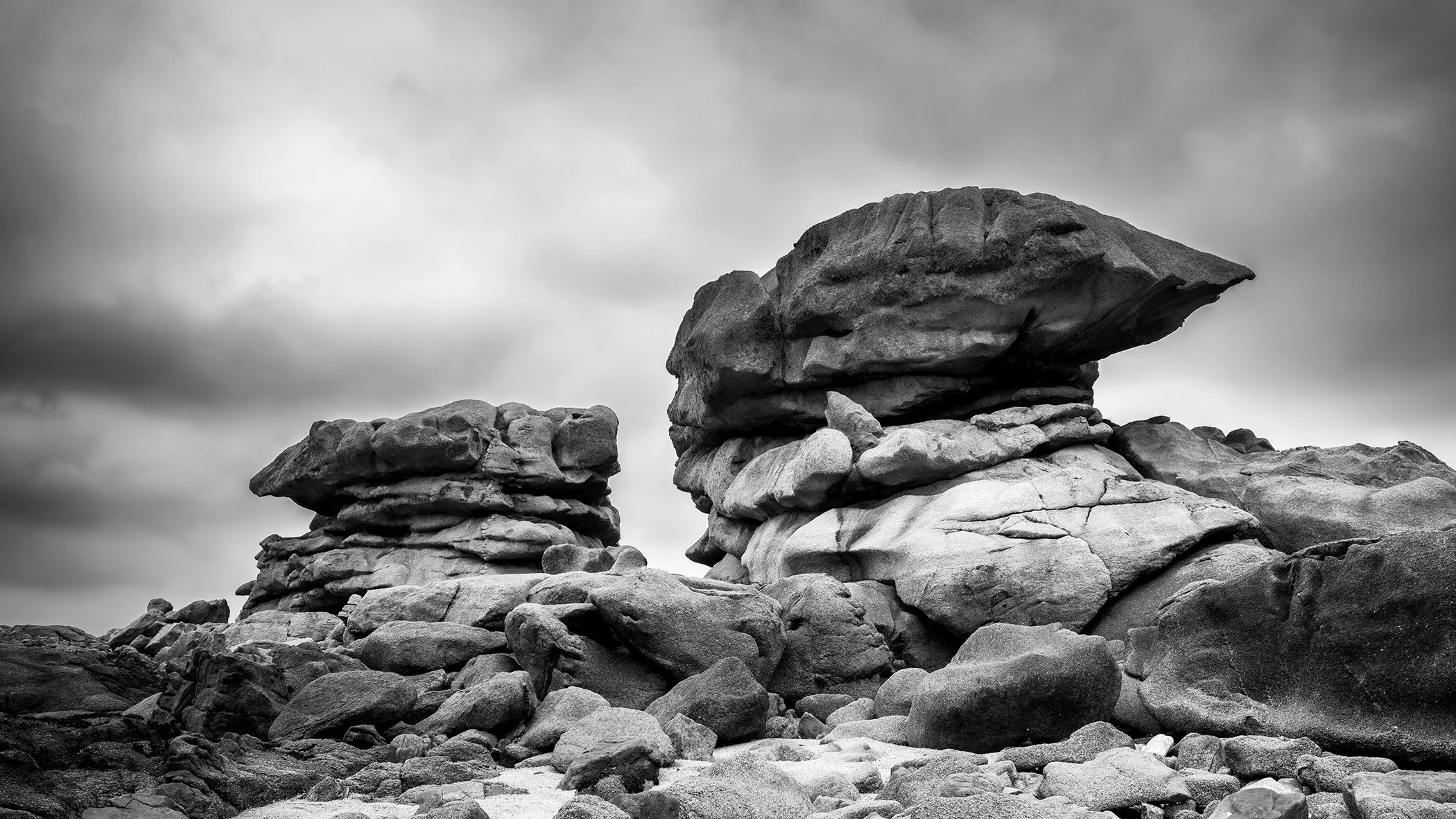 Pink Granite Coast Panorama Study 1 by Gerald Berghammer, black-and-white fine art photograph of monumental granite formations on Brittany’s Pink Granite Coast in France.