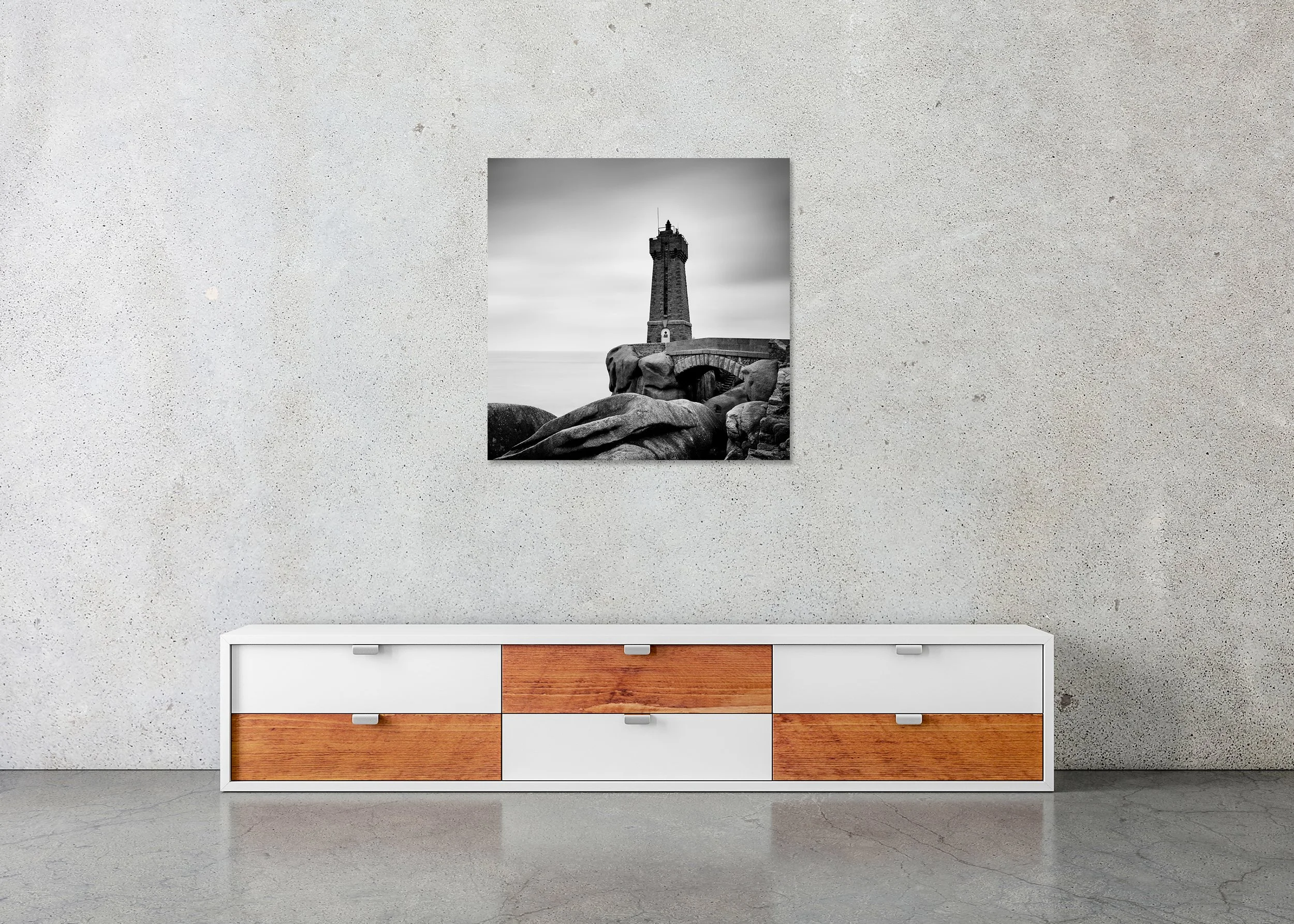 Ploumanac’h Lighthouse – Brittany, frameless black-and-white photograph on aluminium Dibond displayed in a minimalist interior.