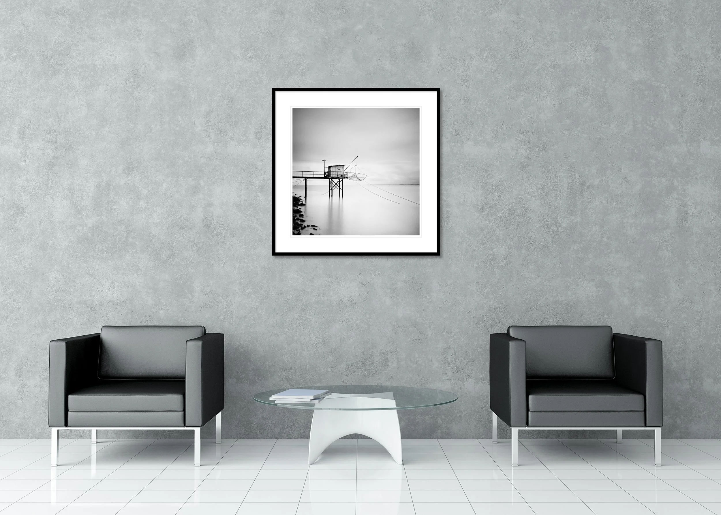 Minimalist black-and-white long-exposure photo of a traditional fishing hut on stilts with nets over a calm sea, archival pigment print in a classic frame.