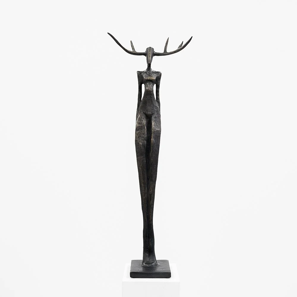 Abstract bronze sculpture of a tall elongated female figure with antlers, minimalist modern art statue by Nando Kallweit.