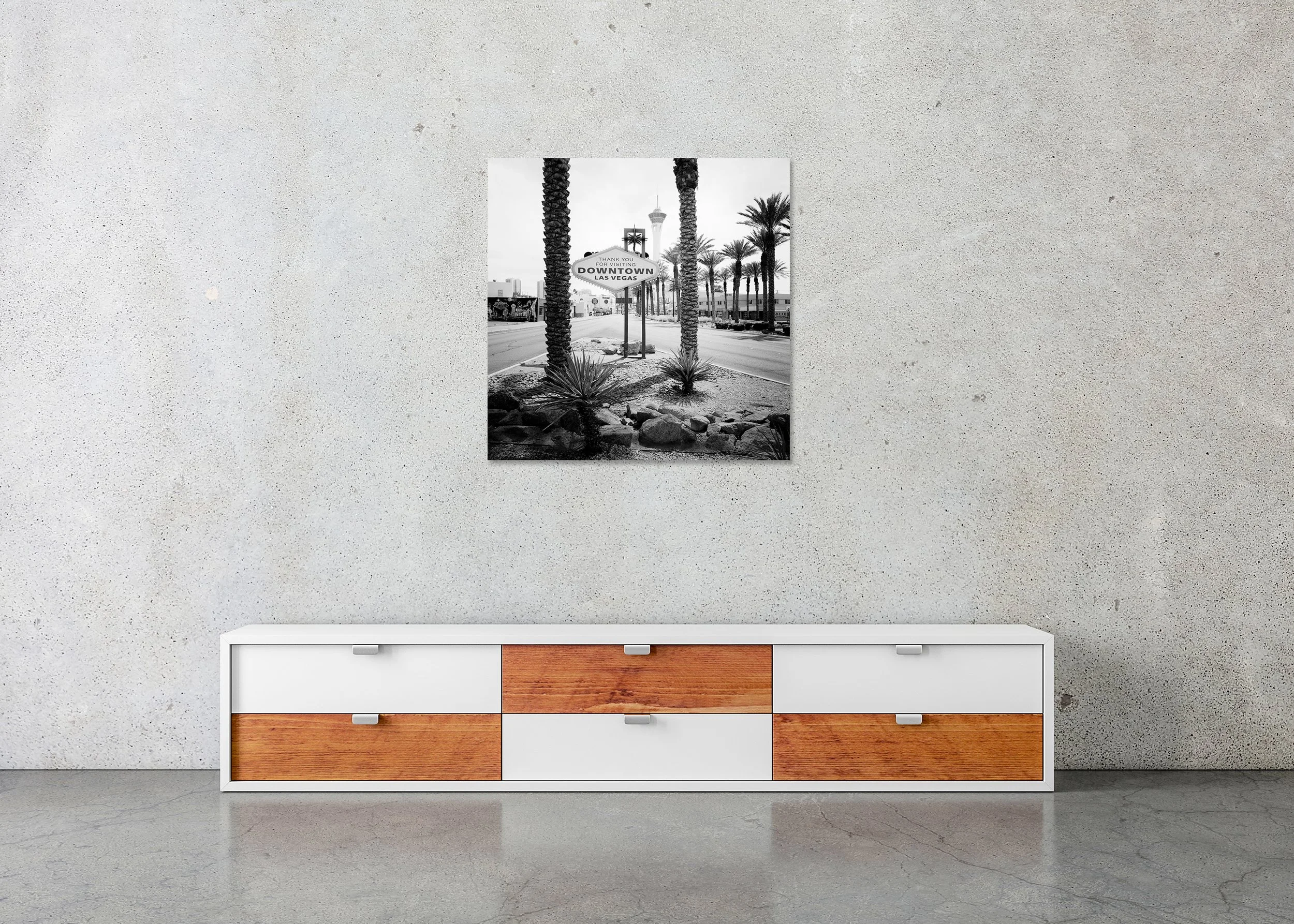 Downtown Las Vegas – frameless black-and-white photograph on aluminium Dibond displayed above a low cabinet in a minimalist interior.