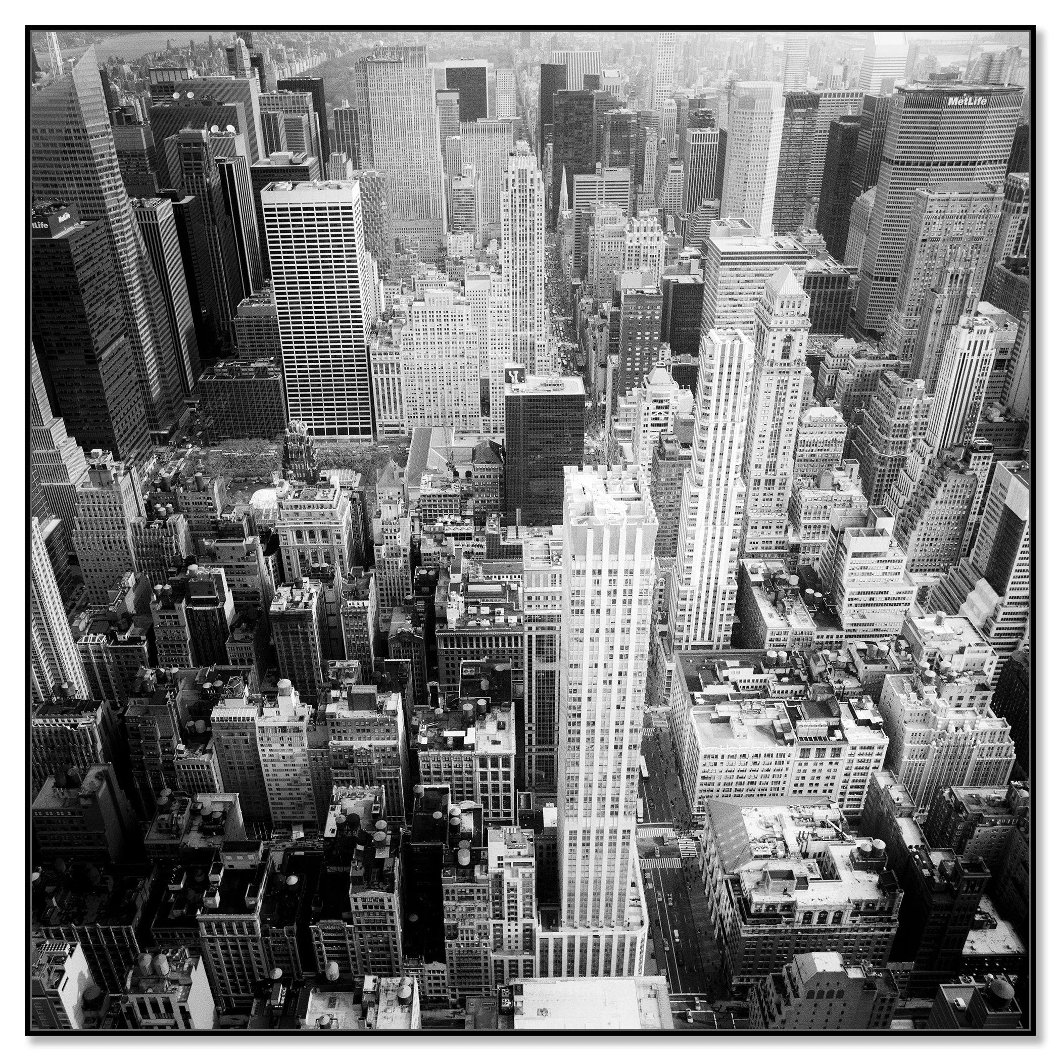 Black-and-white aerial view of New York City skyscrapers and dense urban streets, fine art cityscape photograph – framed ArtBox black