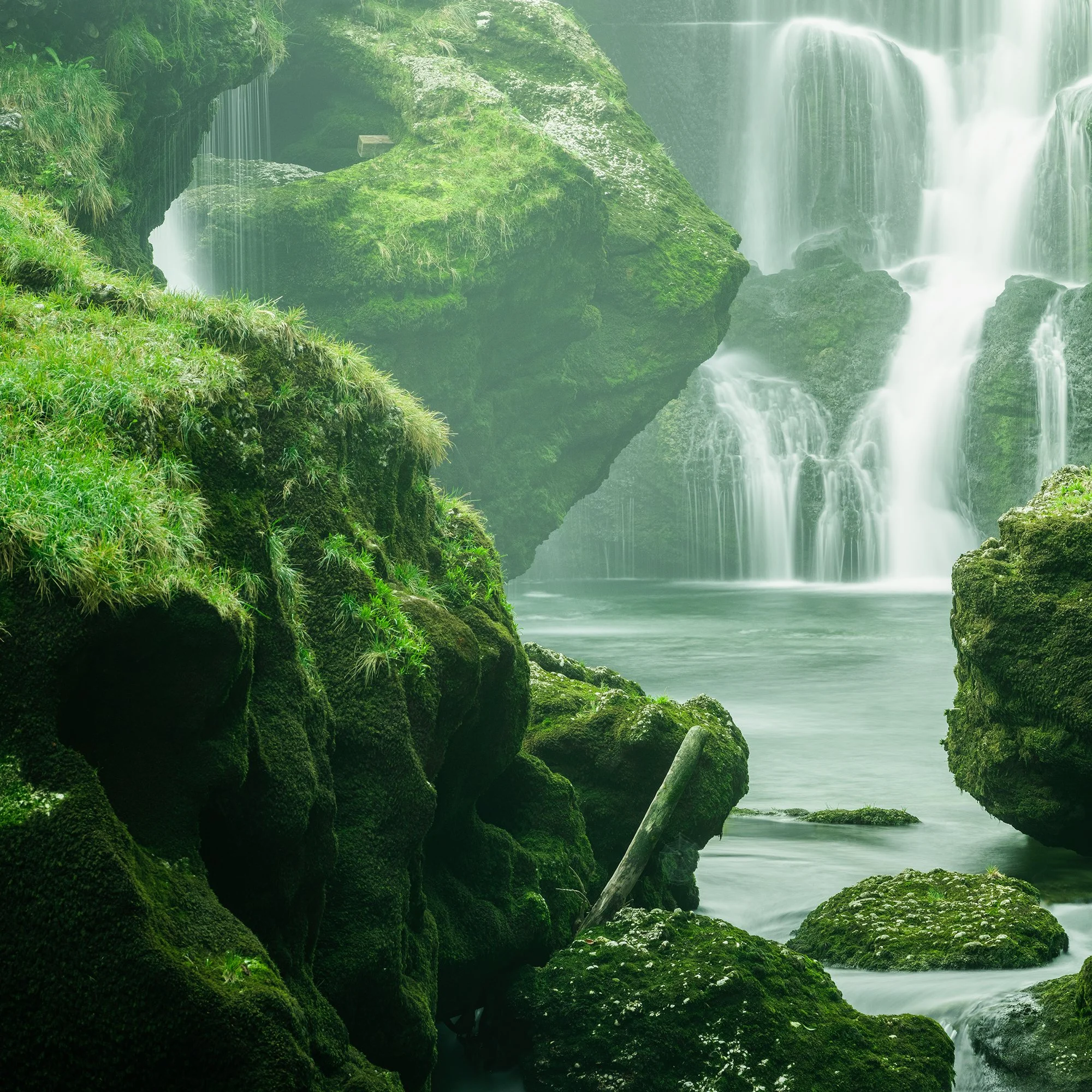 Detail of Moss-Covered Waterfall Study 1 showing silky long-exposure water beside vivid moss-covered rocks in Austria by Gerald Berghammer.
