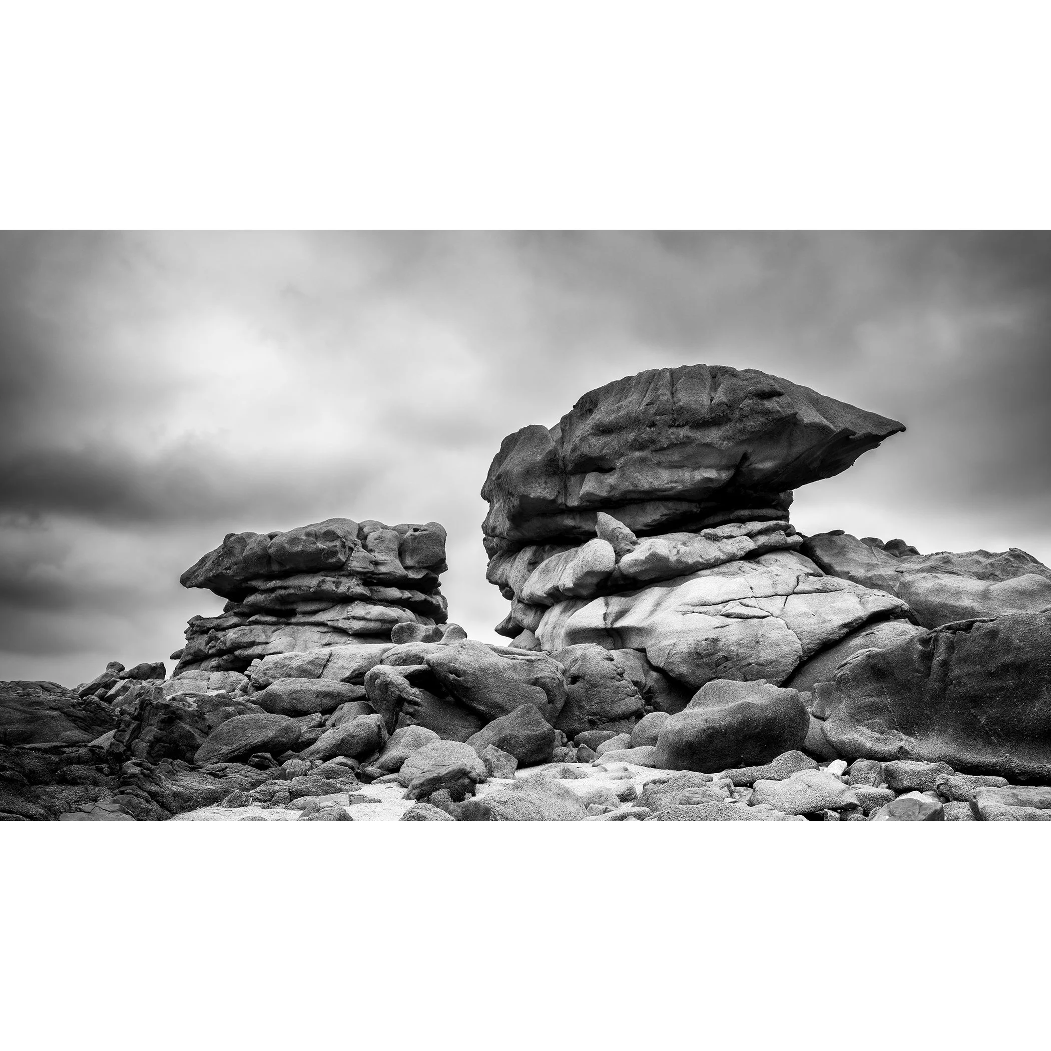 Pink Granite Coast Panorama Study 1 by Gerald Berghammer, black-and-white fine art photograph of monumental granite formations in Brittany, France.