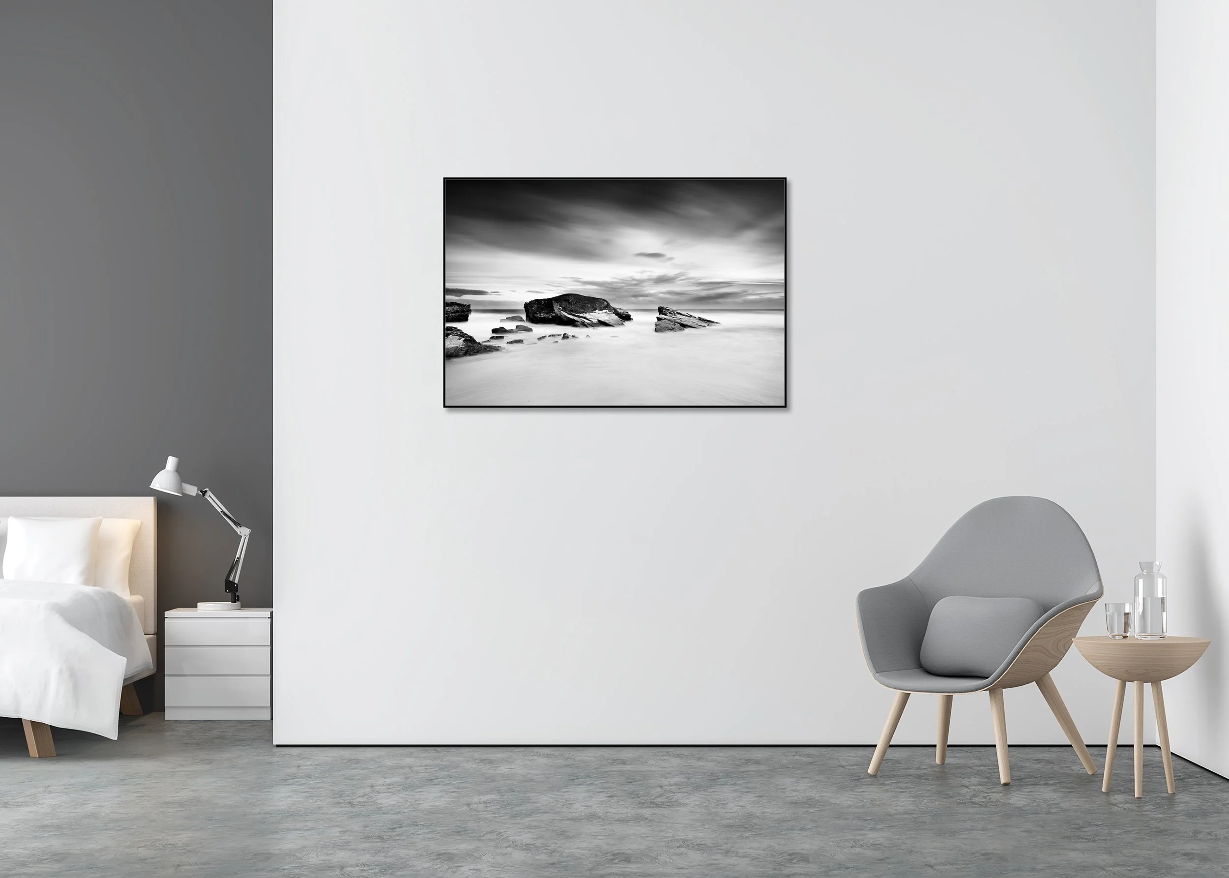 Monochrome long-exposure seascape printed on ChromaLuxe metal with an aluminium ArtBox showing a rocky coast with large boulders in smooth water under overcast clouds