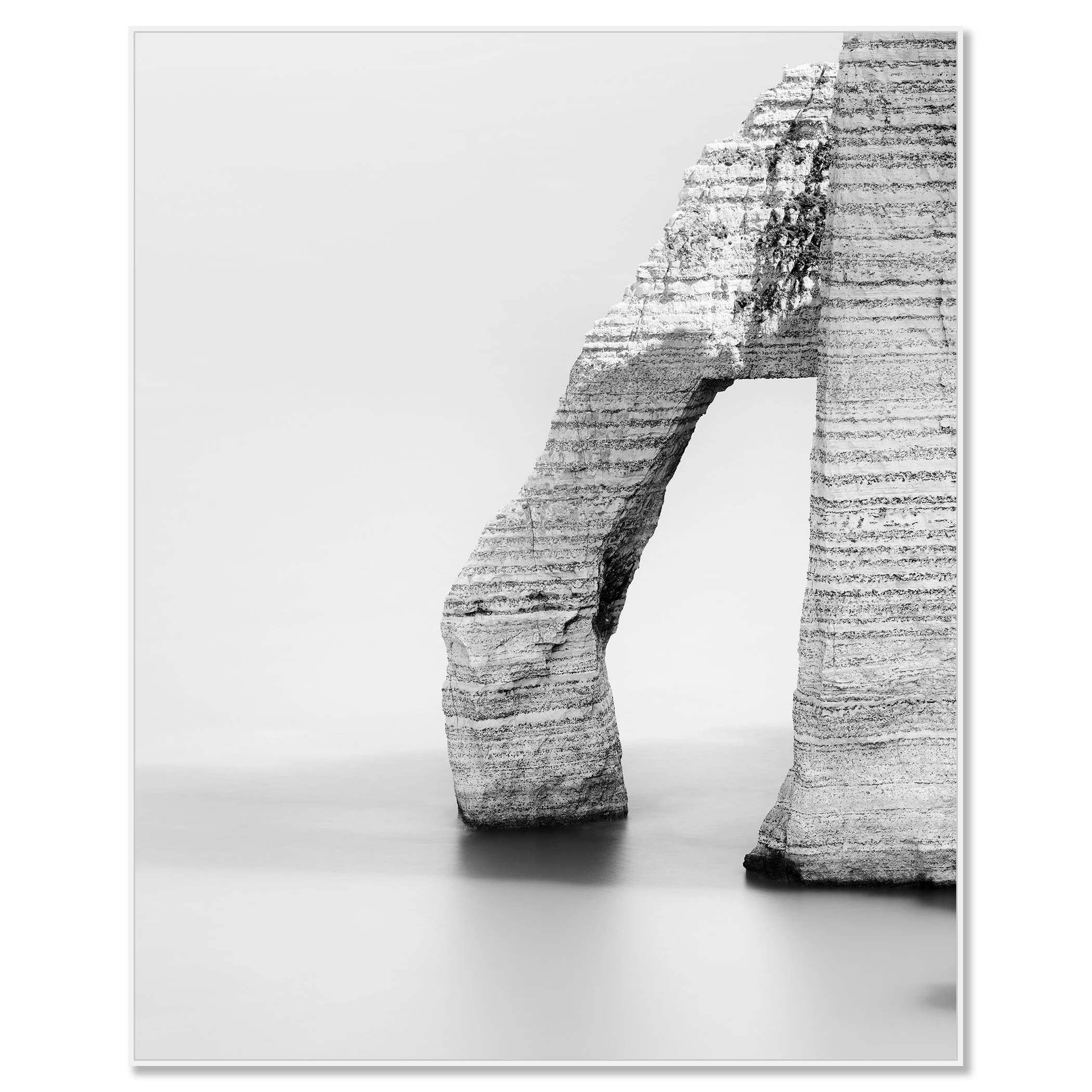 Black and white photo of a minimalist stone arch sculpture with layered texture on a soft gray background – framed ArtBox white