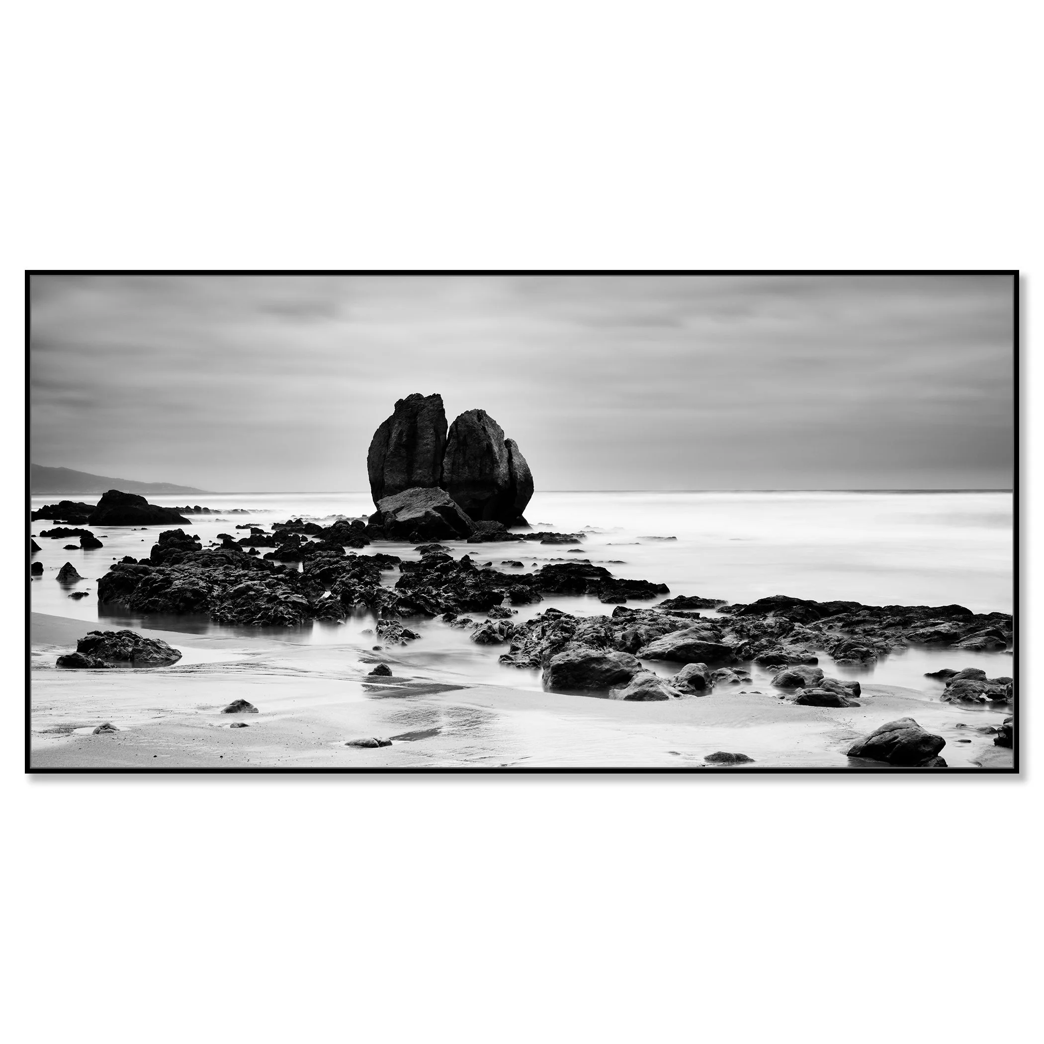 Black and white coastal landscape with large sea rocks on a quiet beach – framed ArtBox black