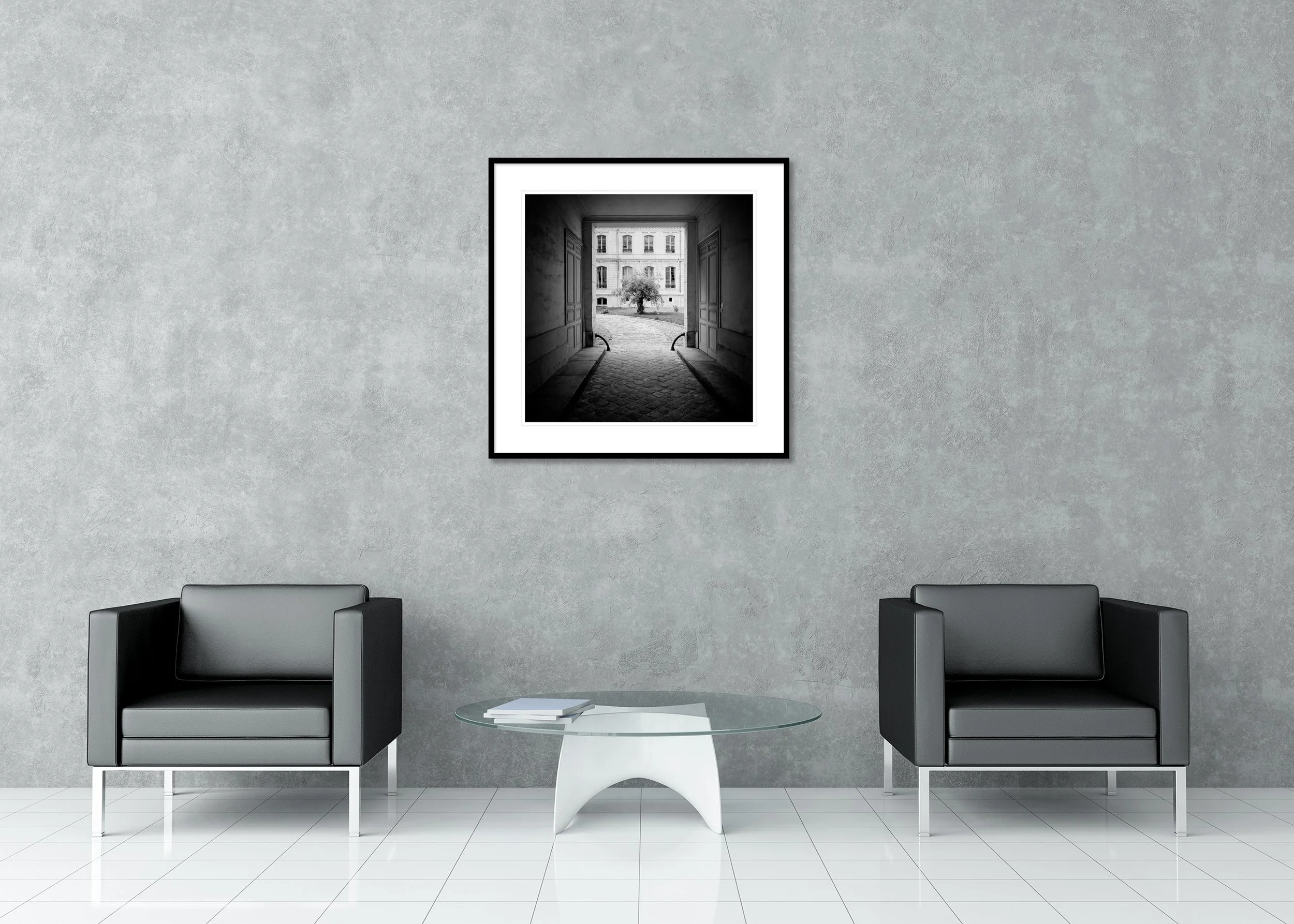 Tree in the Courtyard displayed in a modern interior as an archival pigment print in a black aluminium frame with a white mount by Gerald Berghammer.