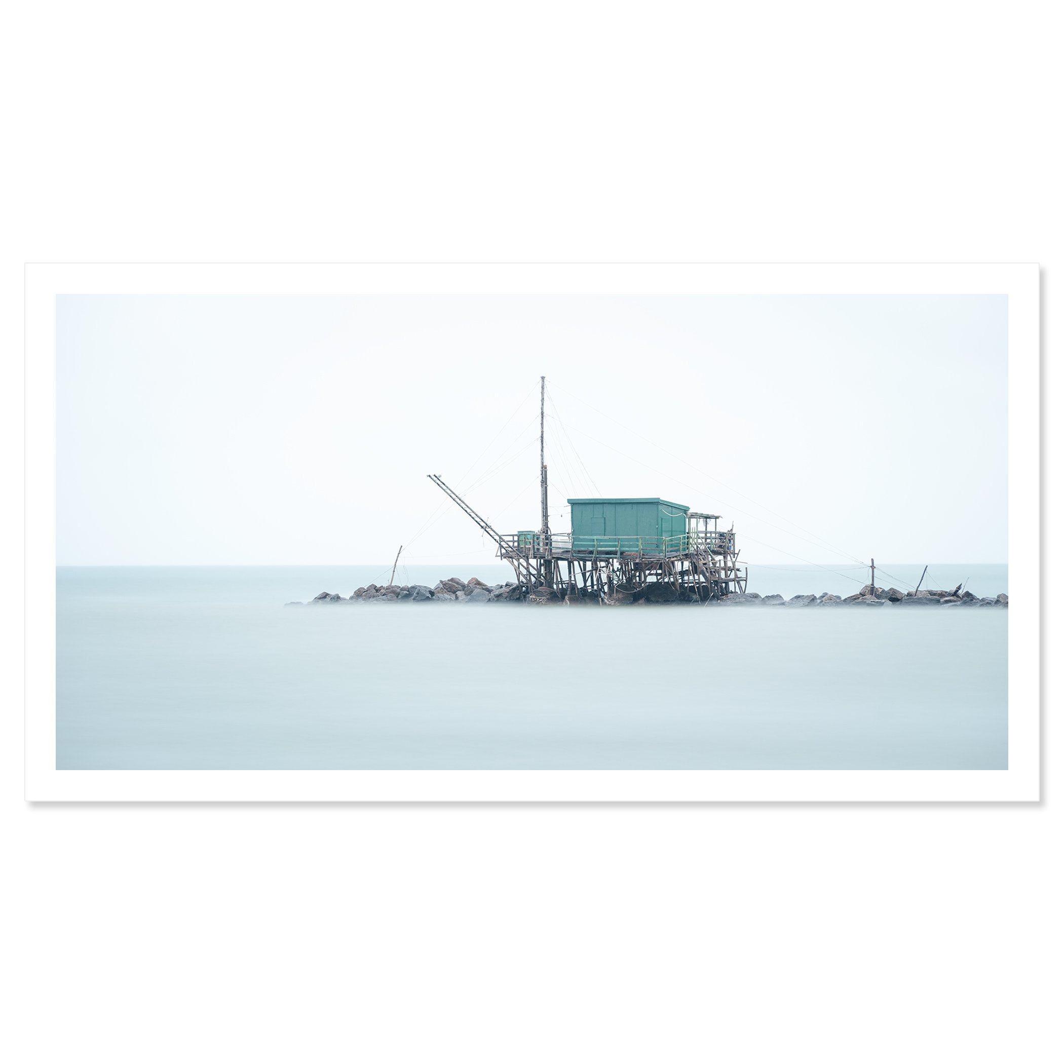 © 2024 Gerald Berghammer - Color minimalist photography. A small house built on stilts over water on rocks, with a fishing pole, in a minimalist, misty seascape. Fine art print only