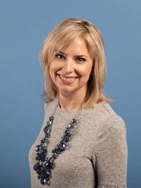 Portrait of Zeal Communications Founder Lauren Lawson Zilai on a blue background