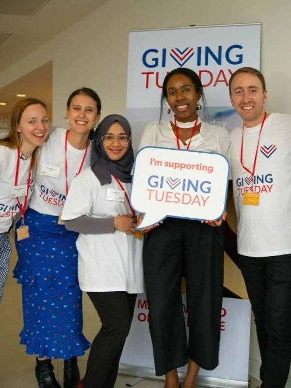 A group of young people support Giving Tuesday.