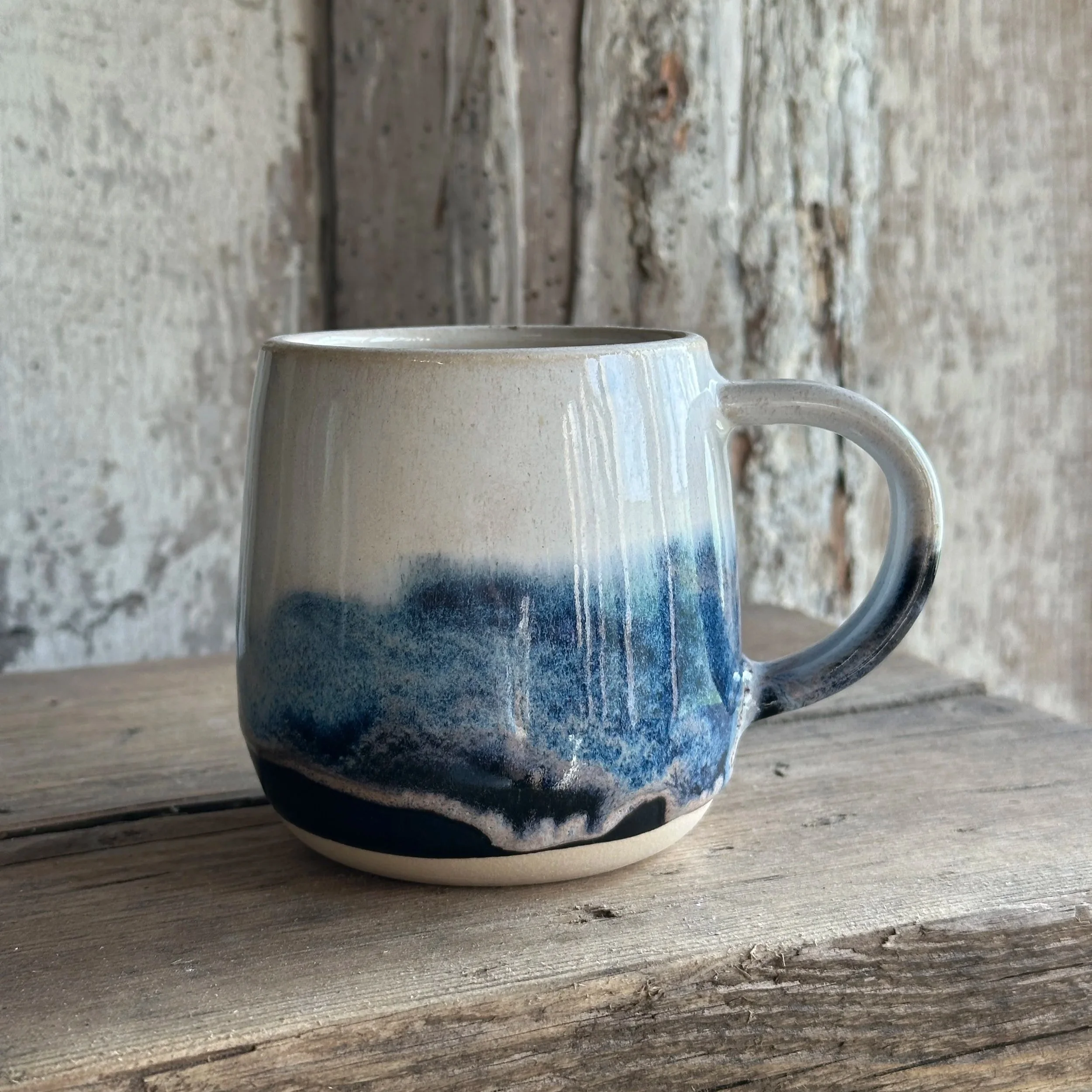 White stoneware mug layered with blue and white glazes named Blue Storm