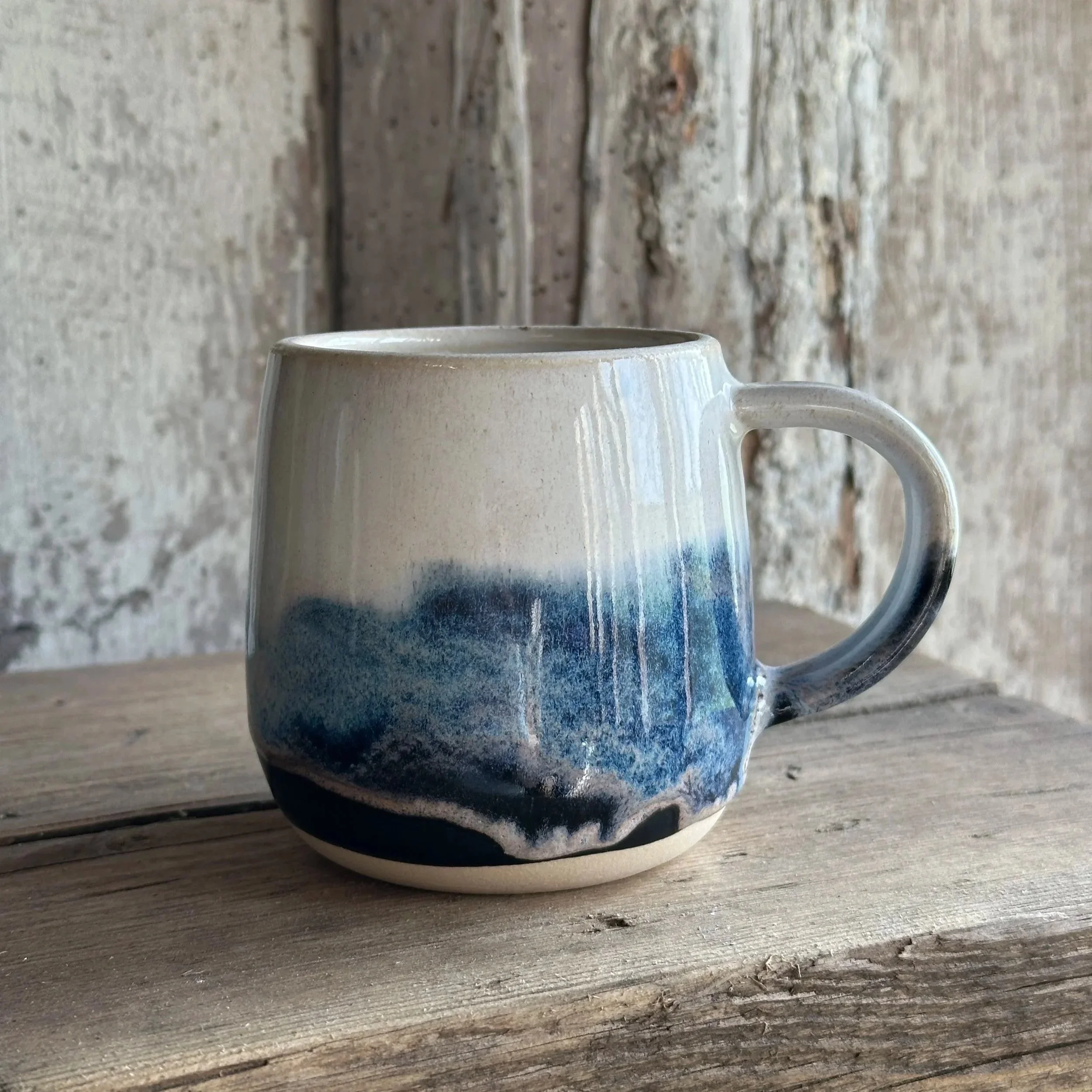 White stoneware mug layered with blue and white glazes named Blue Storm