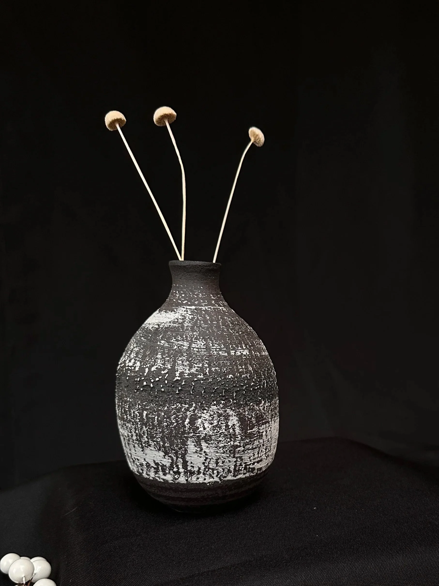 Black narrow neck bottle vase with white and black slip decoration