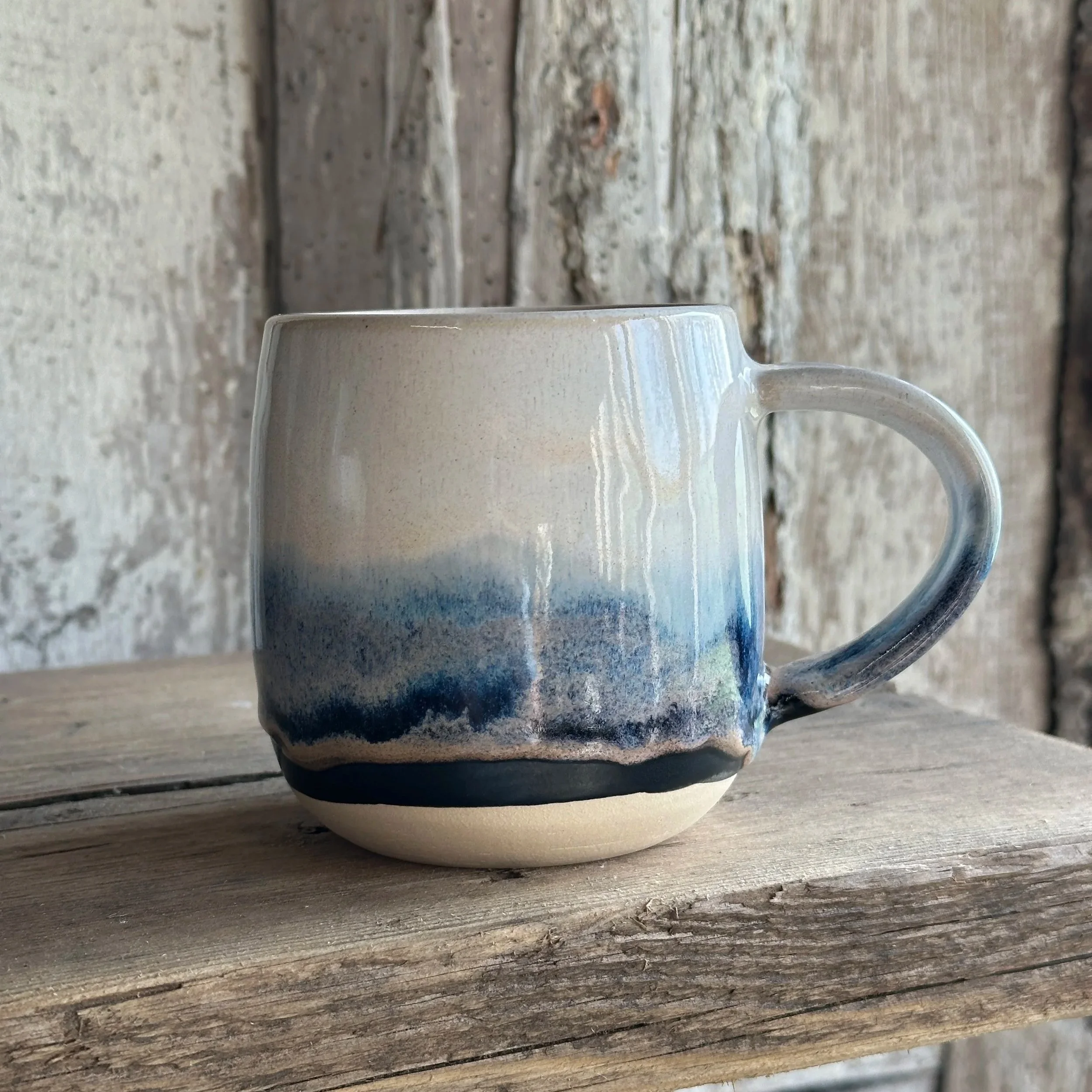 White stoneware mug layered with blue and white glazes named Blue Storm