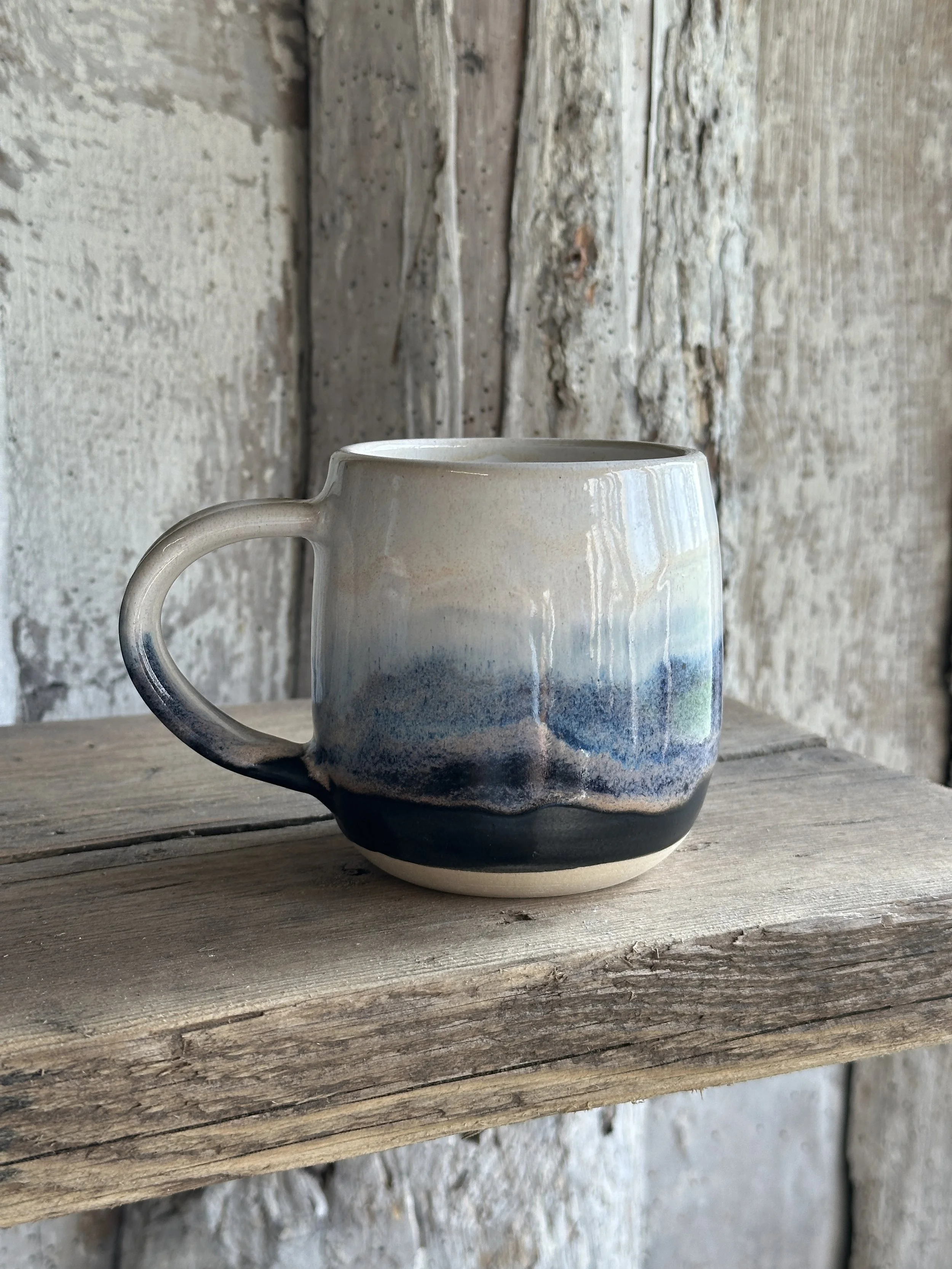 White stoneware mug layered with blue and white glazes named Blue Storm