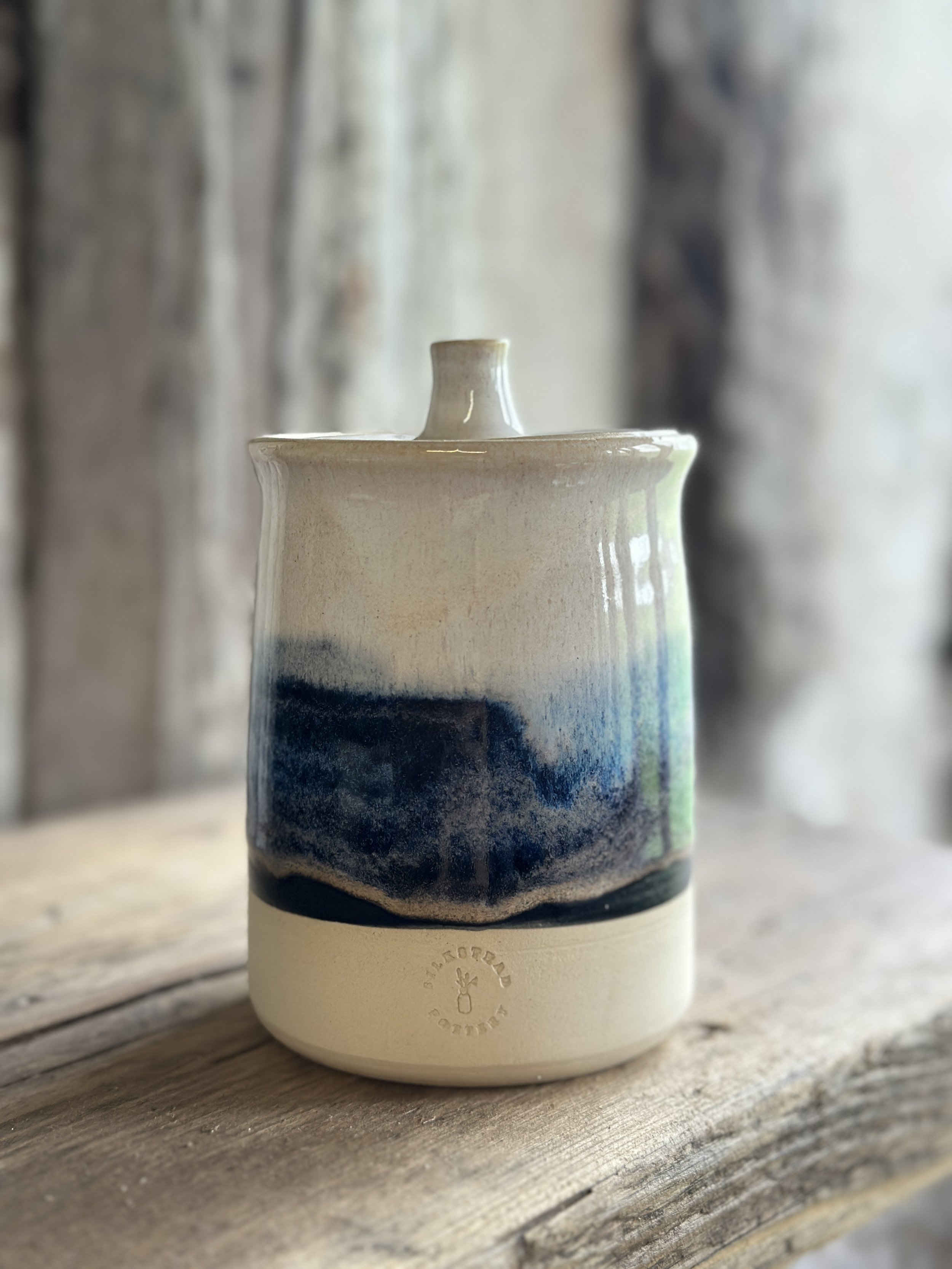 Lidded ceramic pot made from white stoneware clay and glazed with a stormy blue design
