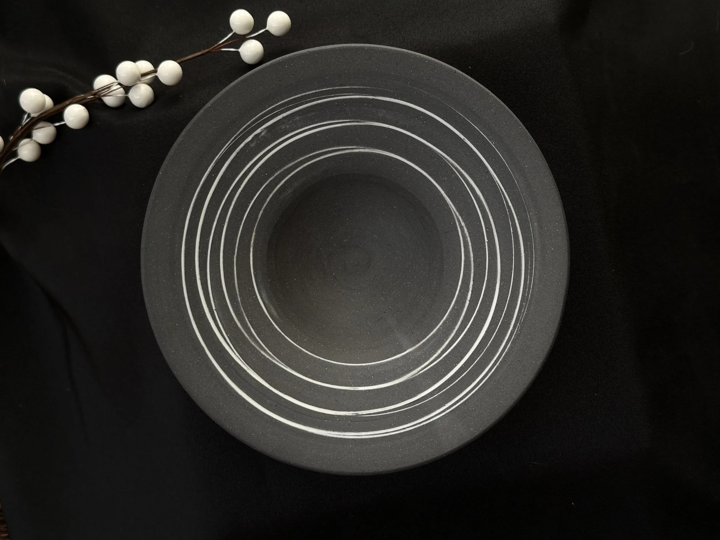 Black porcelain bowl with white slip inlay
