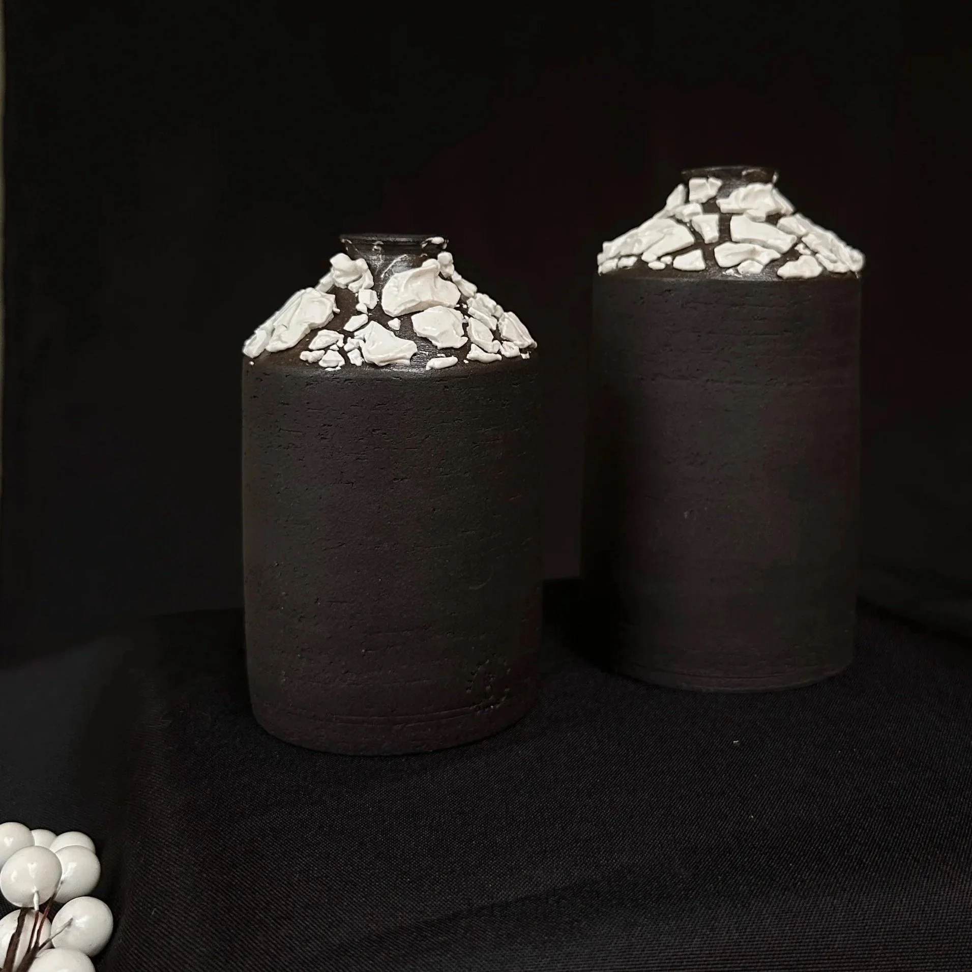 Black stoneware bottle vase with a white crawl lichen glaze