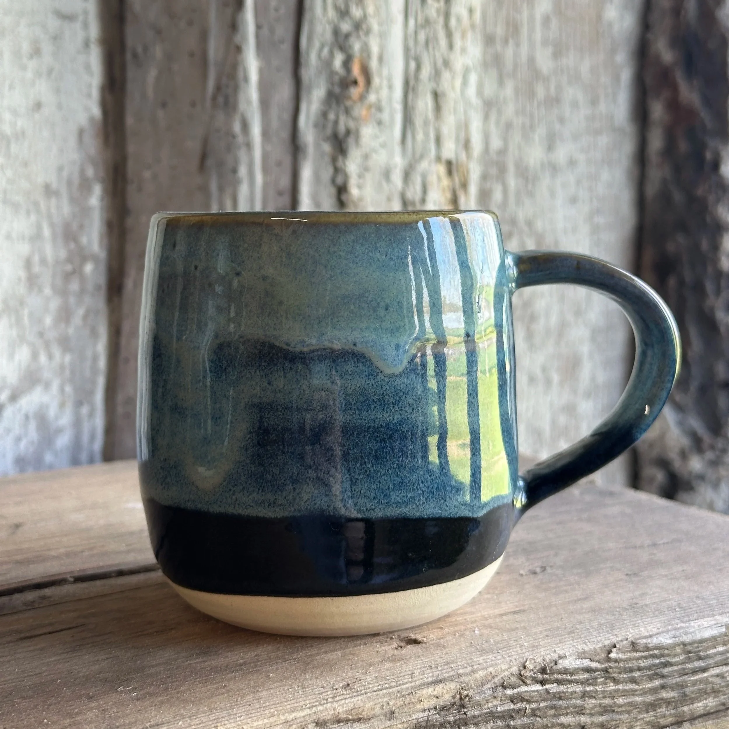 Mug with layers of different blue glazes flowing together
