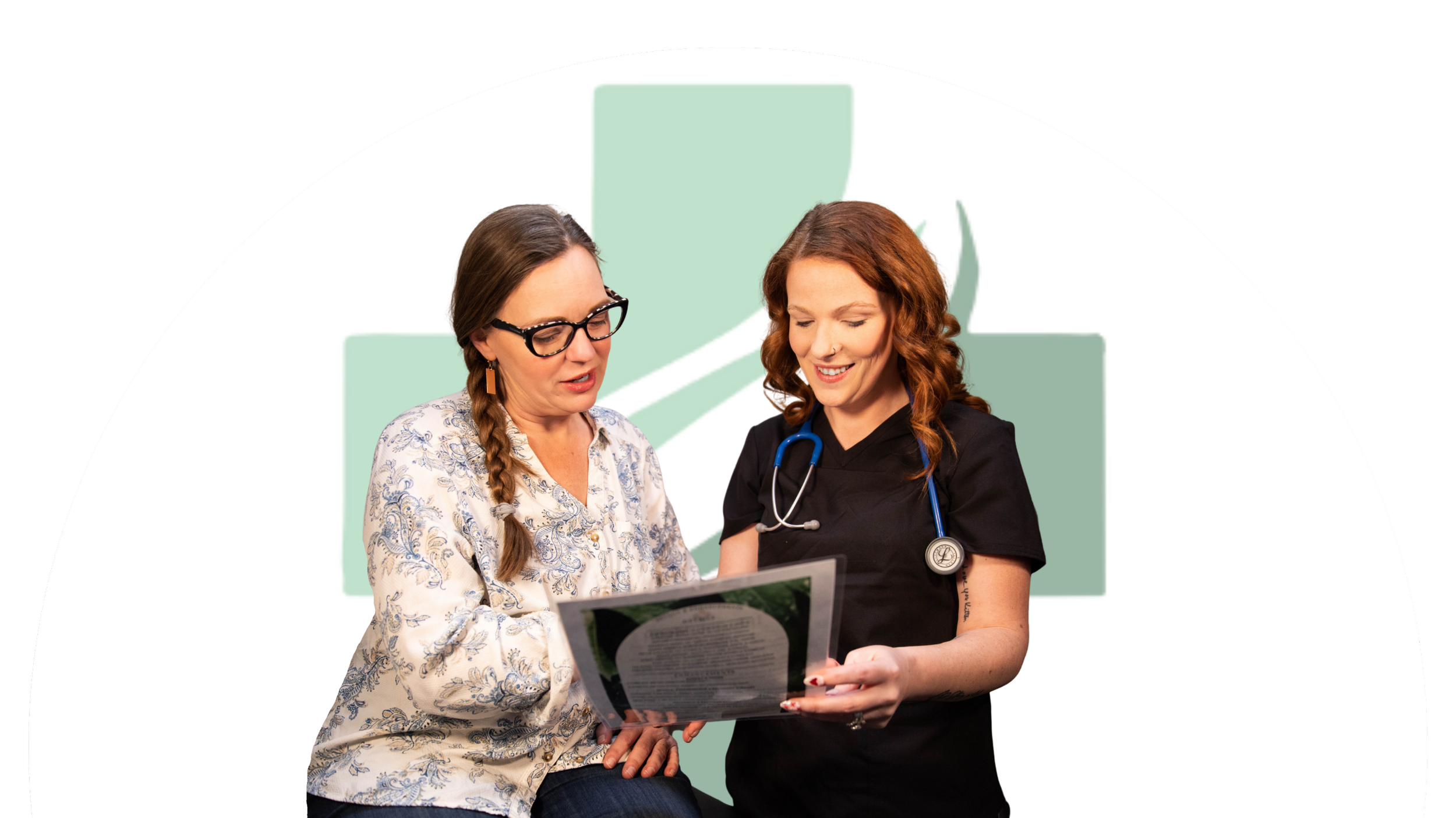 Two female healthcare professionals looking at a document, with a green medical cross logo in the background.