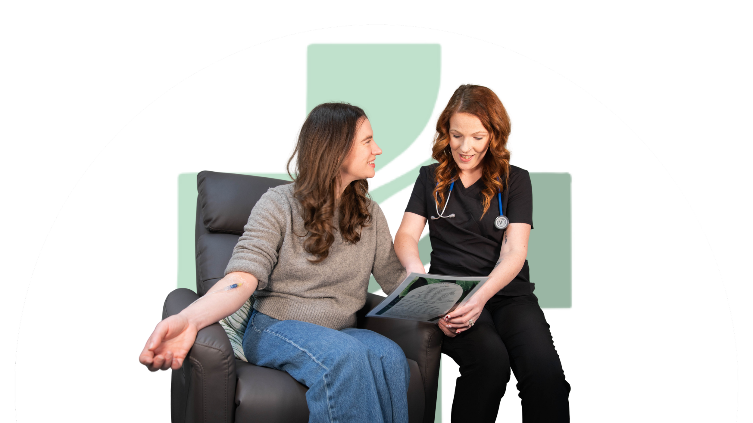 Female patient with a bandage on her arm is consulting with a female nurse holding a clipboard in a medical office or clinic.