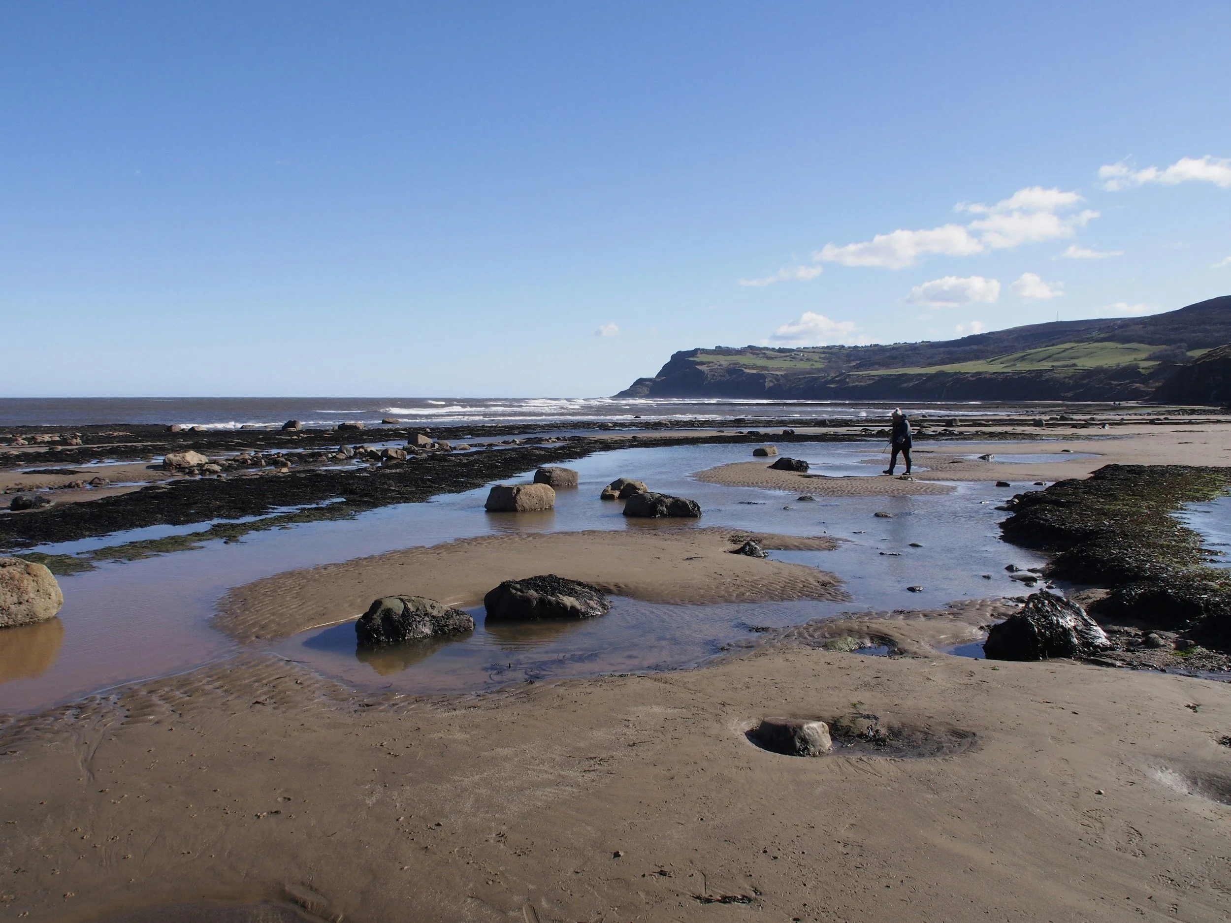 Rock pools and sandy beach at low tide near Robin Hood’s Bay.
