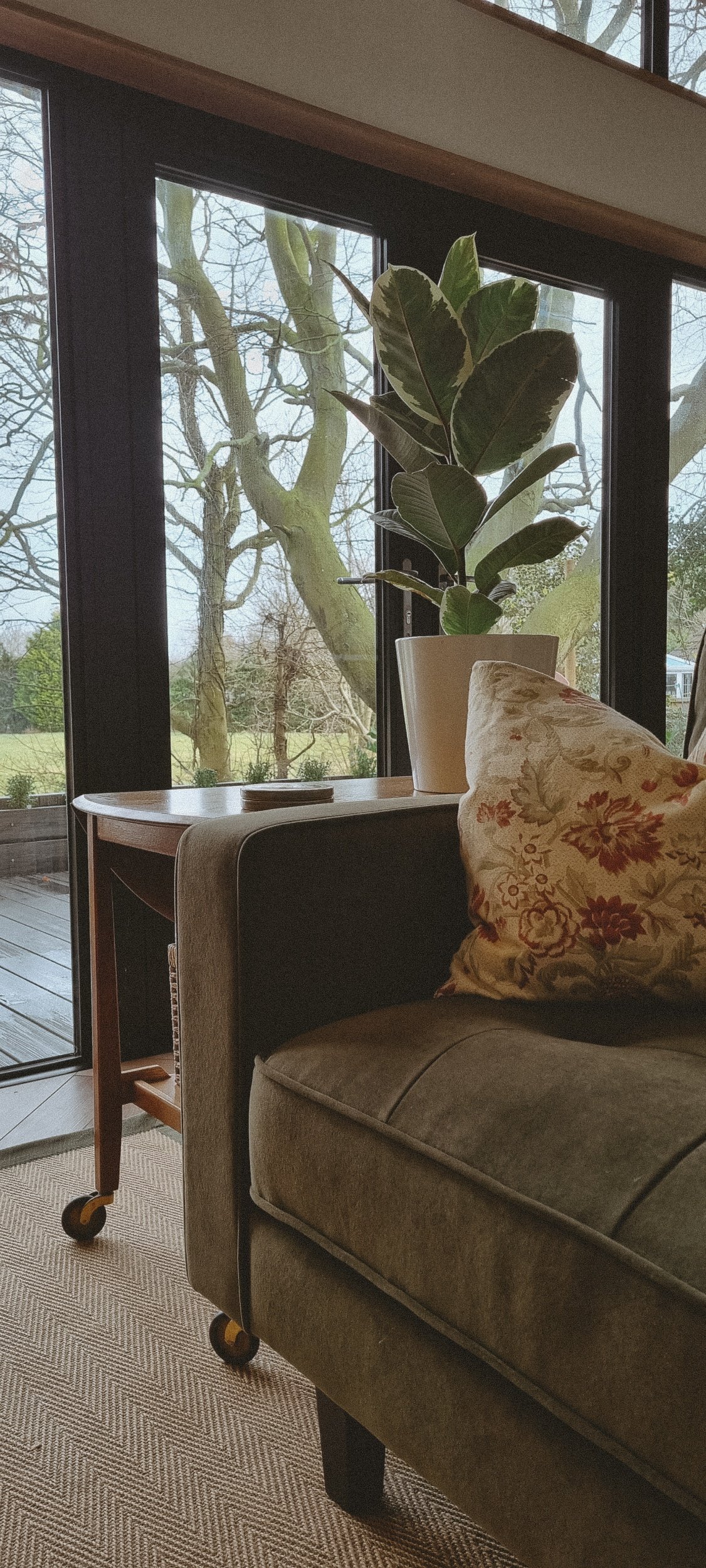 Expansive windows frame garden & countryside views.