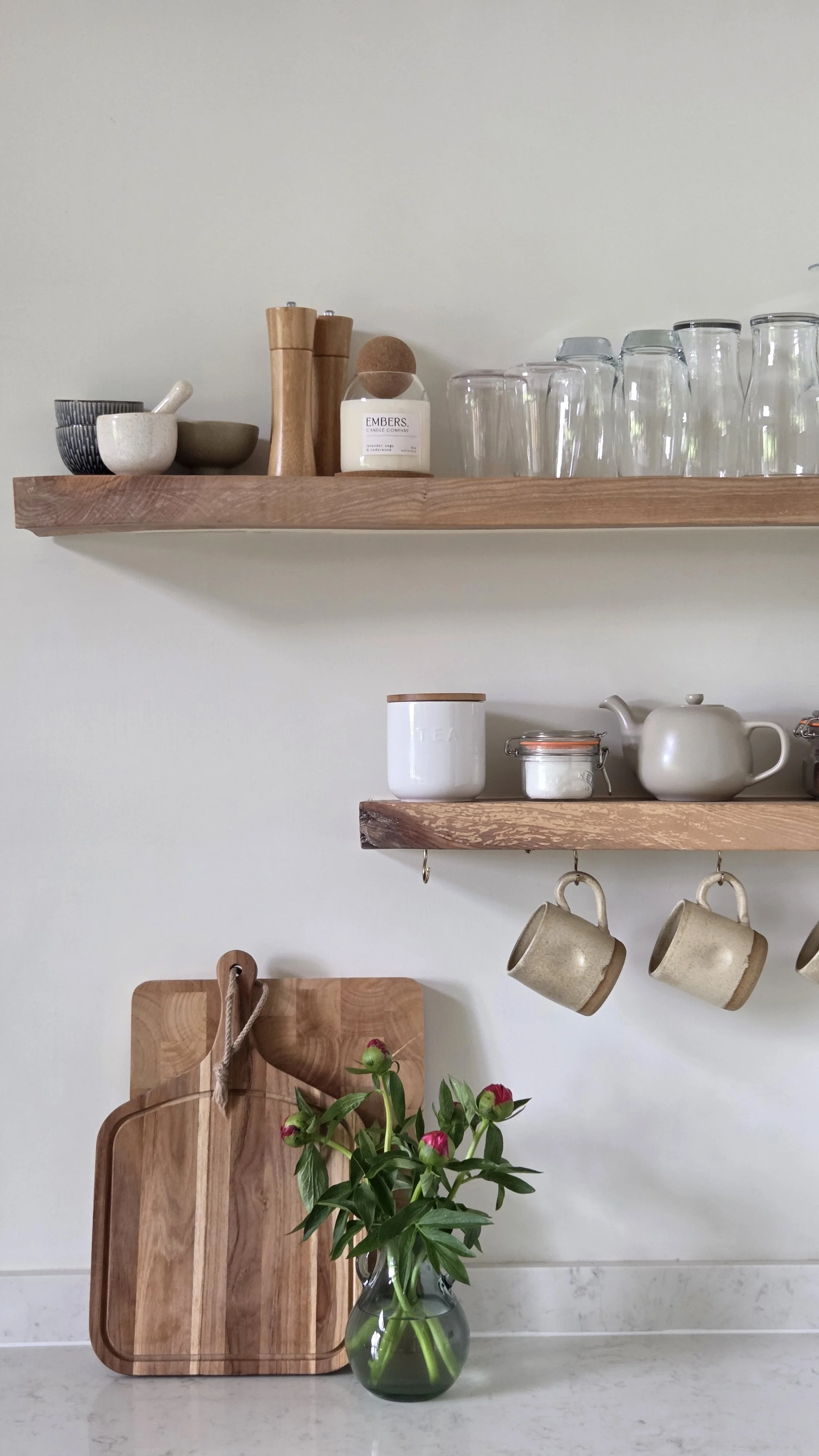 Contemporary kitchen styling with oak shelving and handcrafted ceramics at The Lodge Burniston.