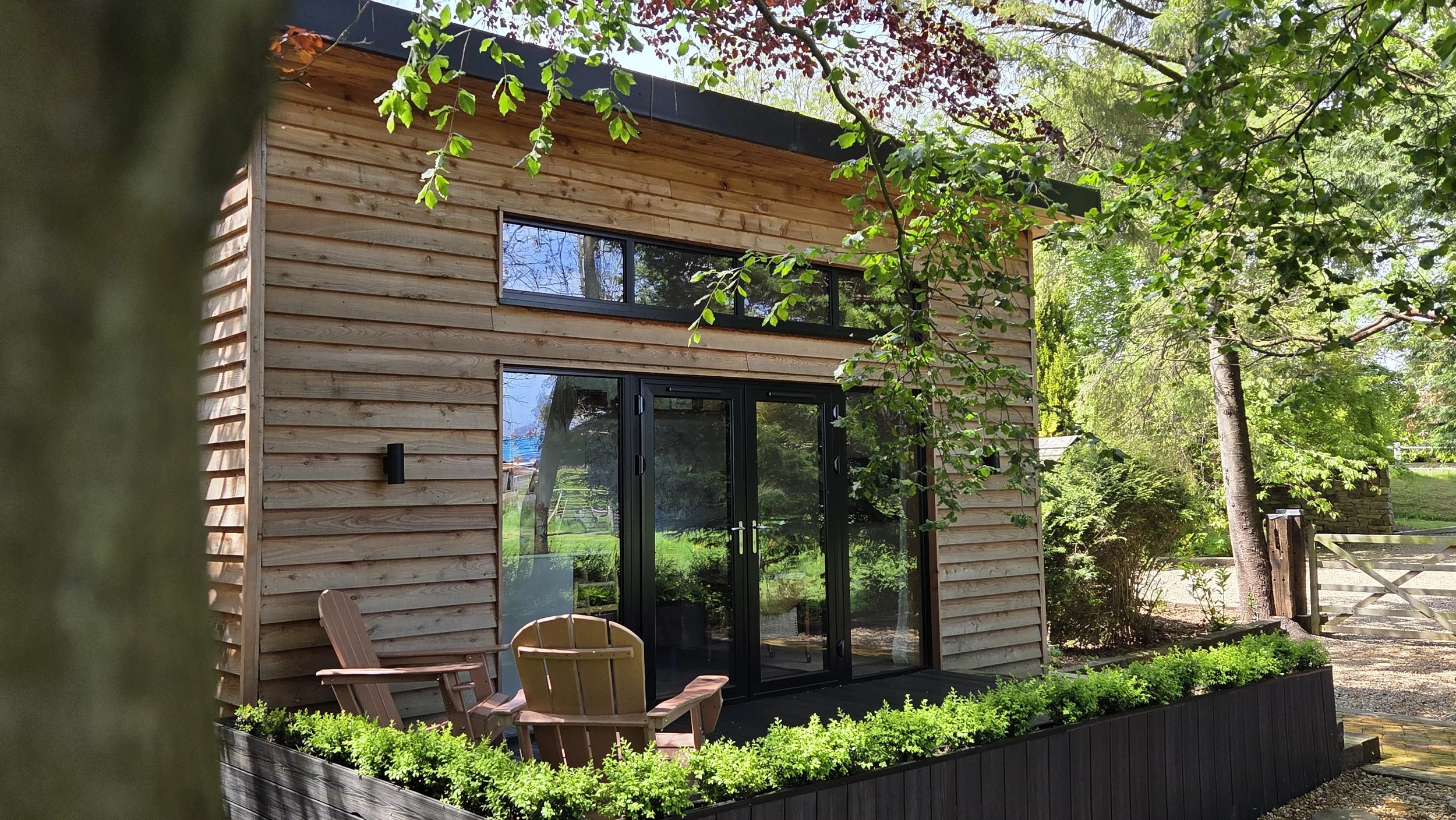 Exterior of The Lodge Burniston luxury cabin on the Yorkshire Coast surrounded by woodland.