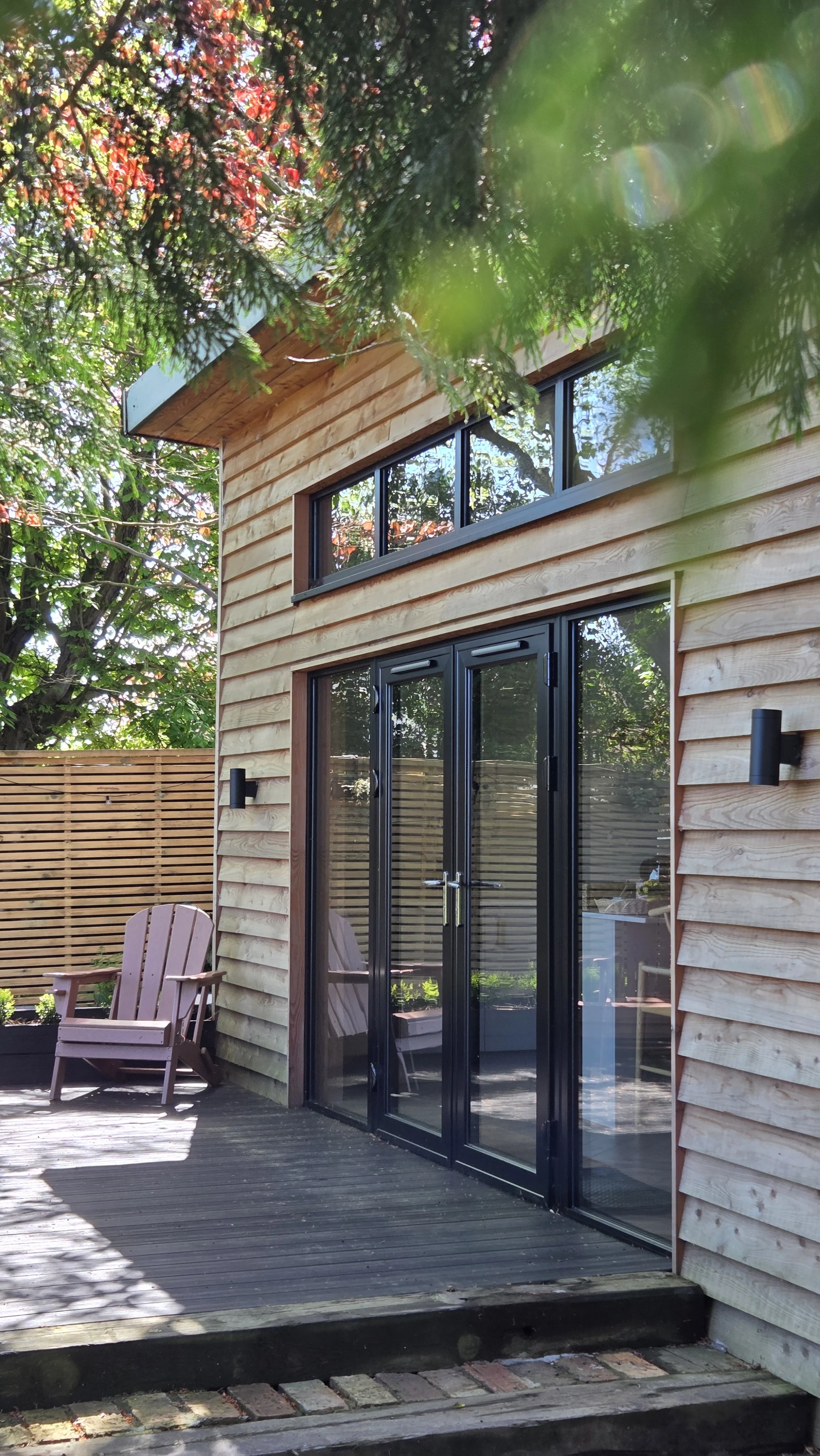 Exterior of The Lodge Burniston, a luxury cabin on the Yorkshire Coast surrounded by mature woodland.