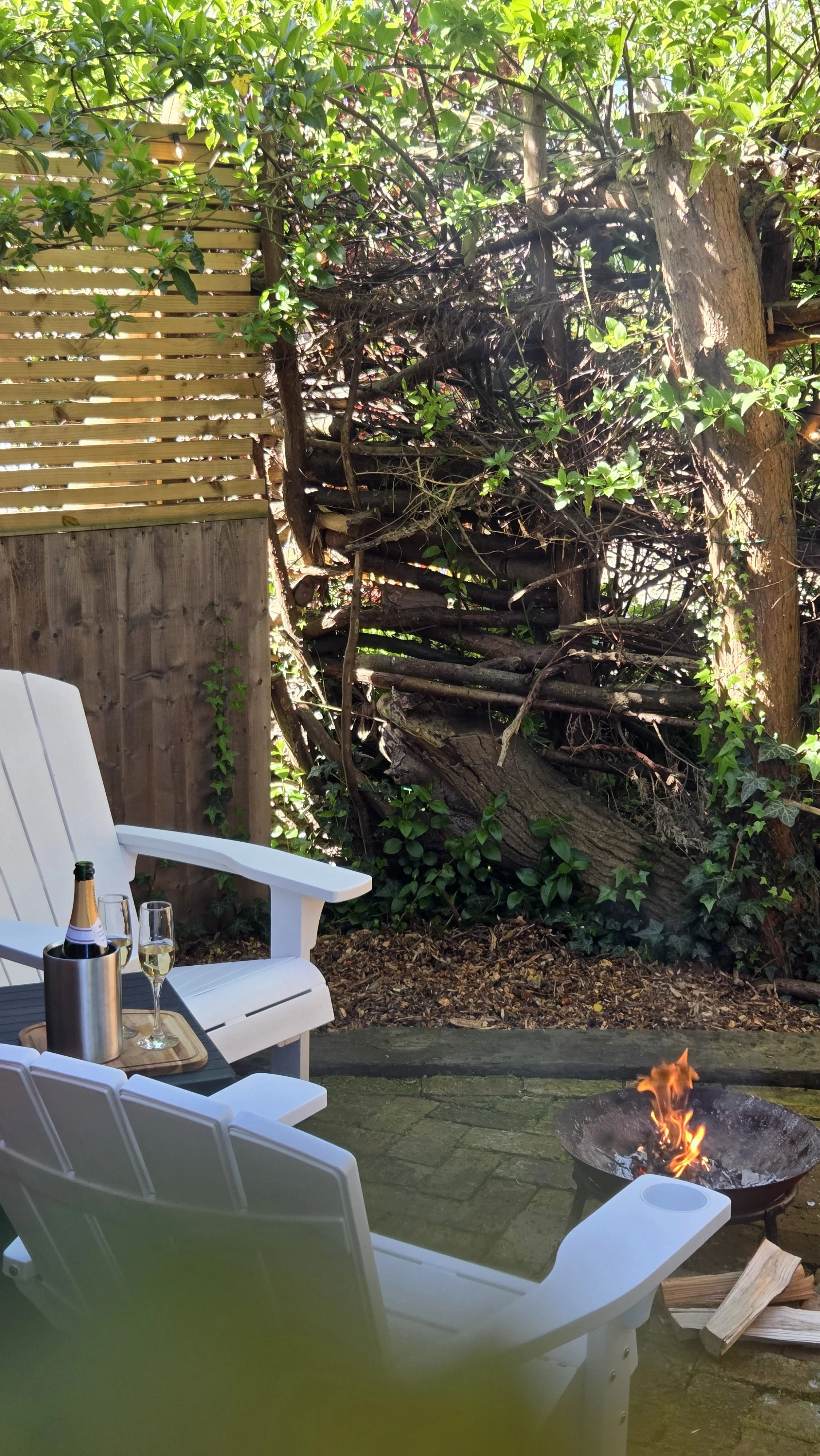 Adirondack chairs surrounding the fire pit at The Lodge Burniston woodland retreat in North Yorkshire.